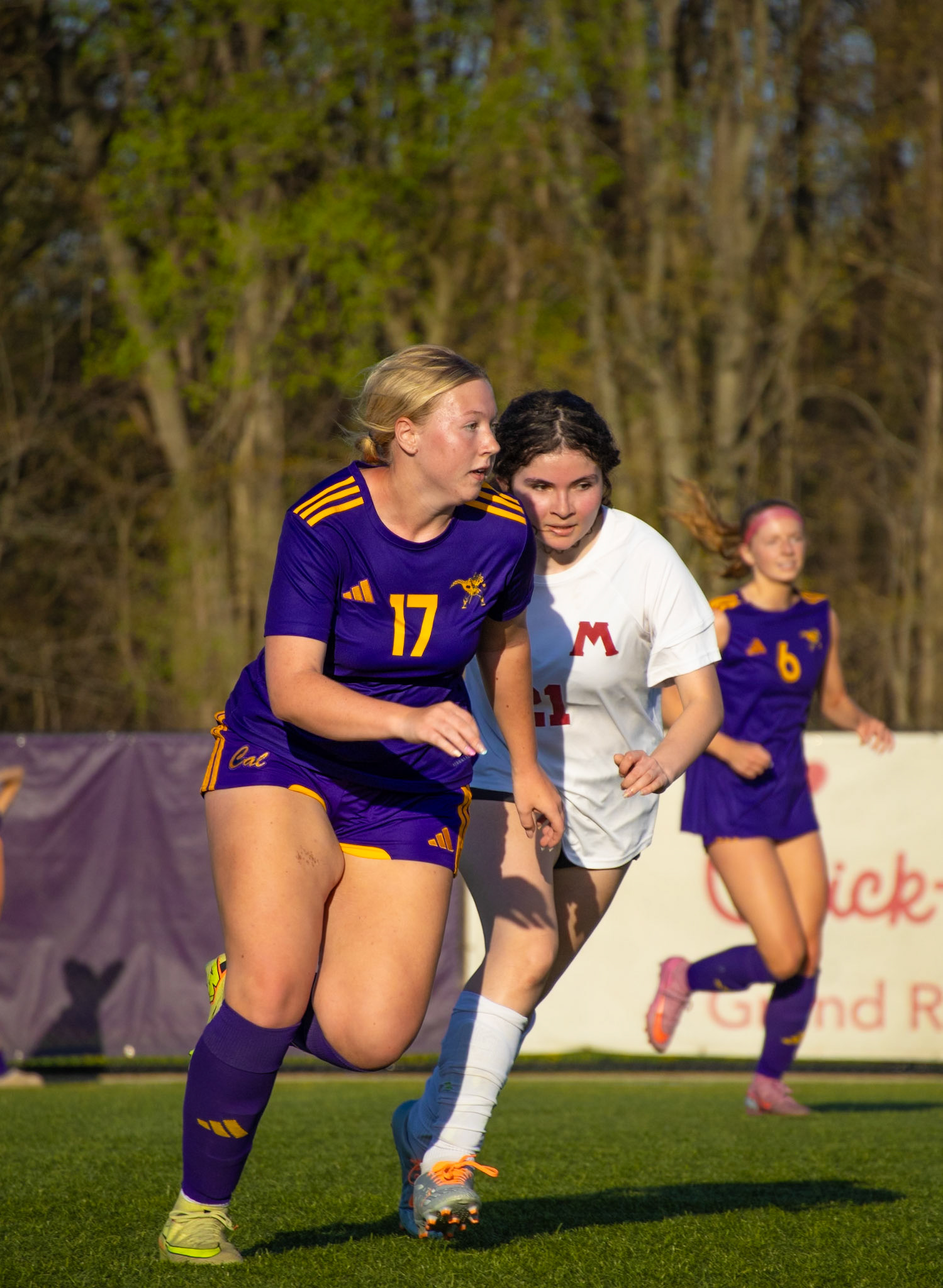 Emily Walbeck anticipates the ball with her defender trailing closely behind, staying one step ahead of the play. (Photo by Aibree Akers)