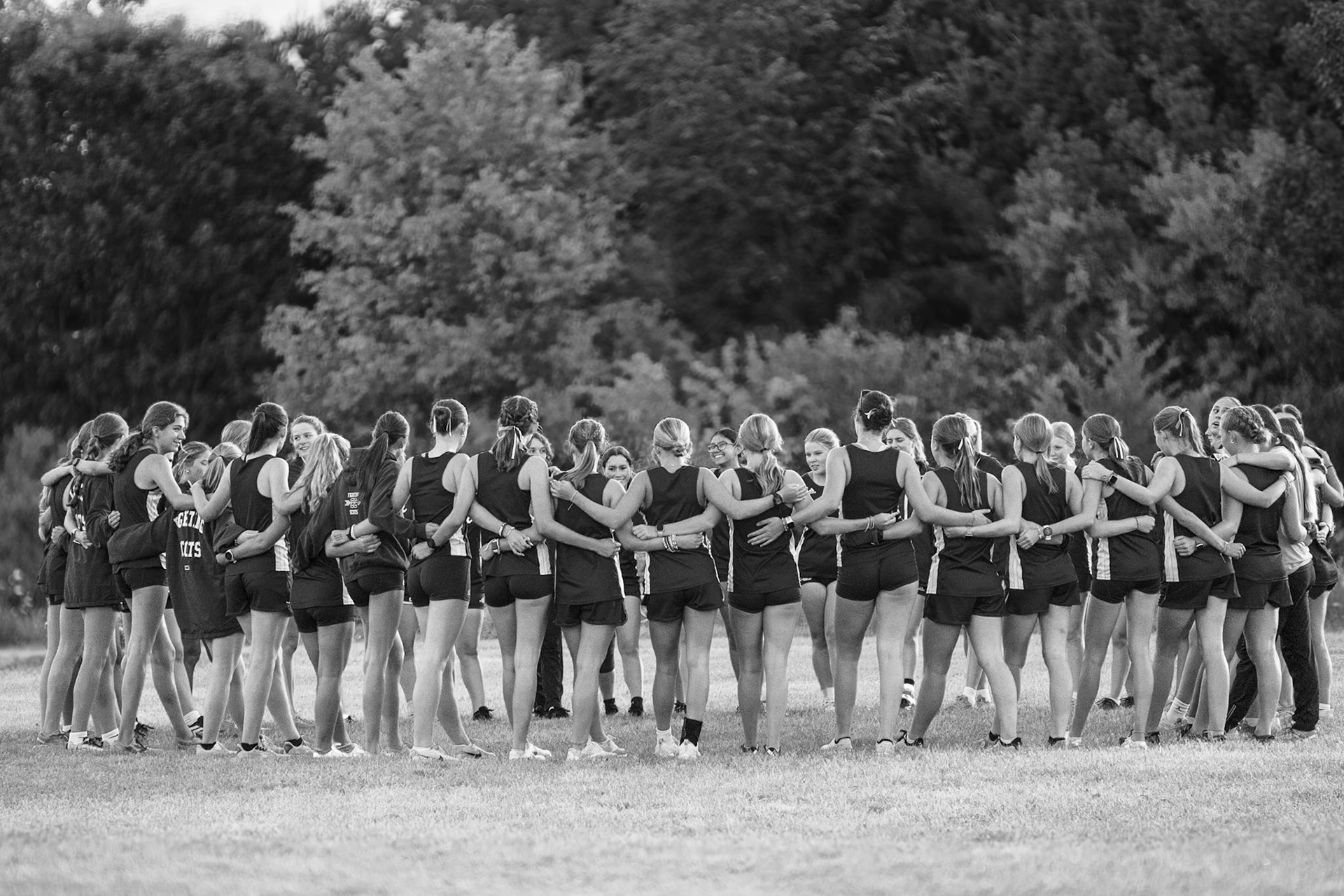 UNITED The girls cross country team huddles up before they dominate the Thornapple-Kellogg Dual meet. (Photo by Caralyn Price)
