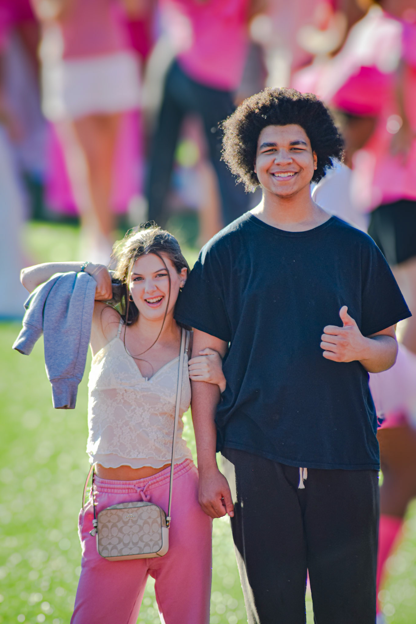 Chris Newman and Ava DeGlopper find some space for a laugh in the temporary student section. (Photo by Ollie Fox)