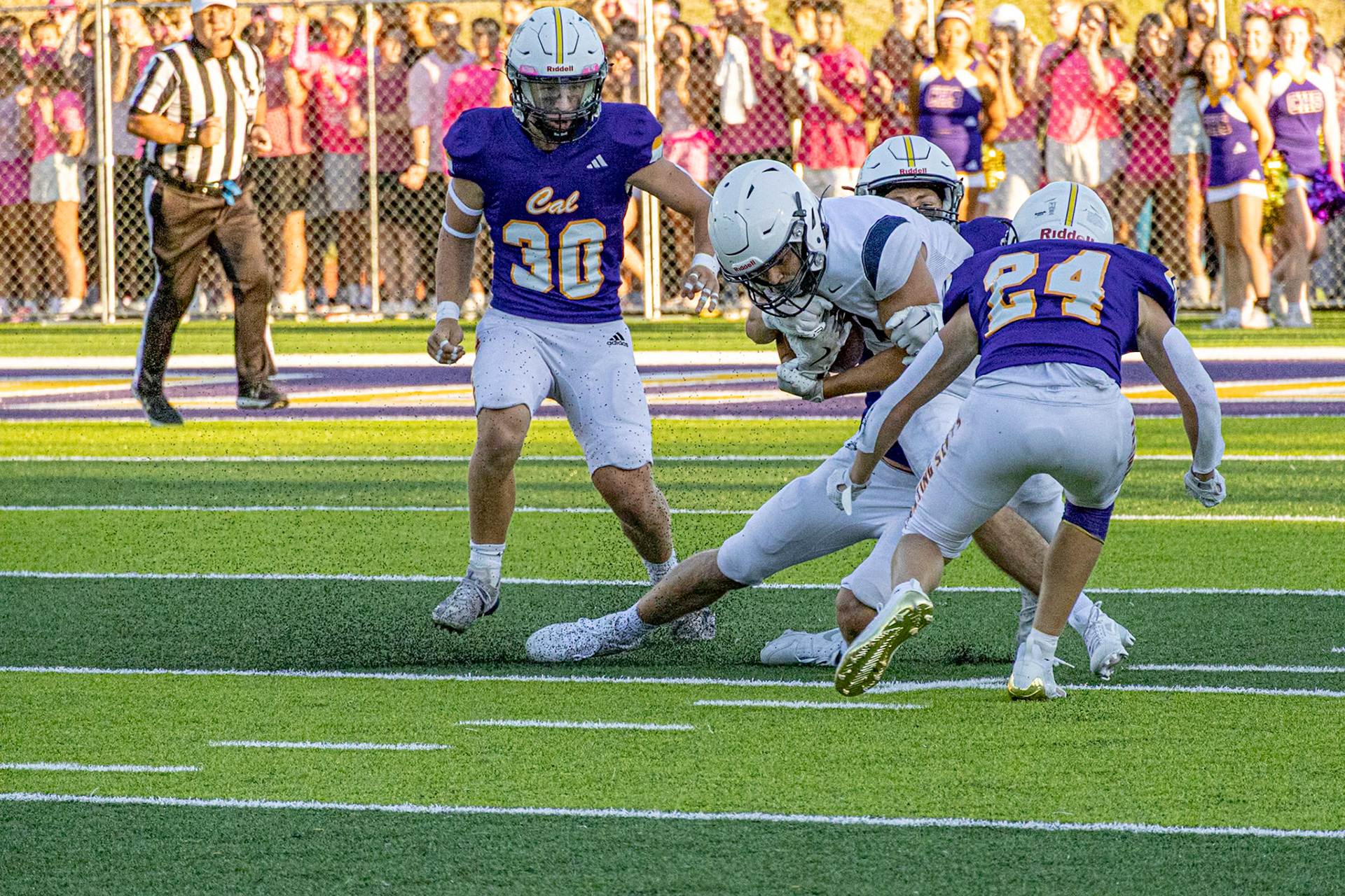 A Holy Windsor ball carrier battles for yards as Caledonian defenders force a fumble moments later. (Photo by Egan Otto)
