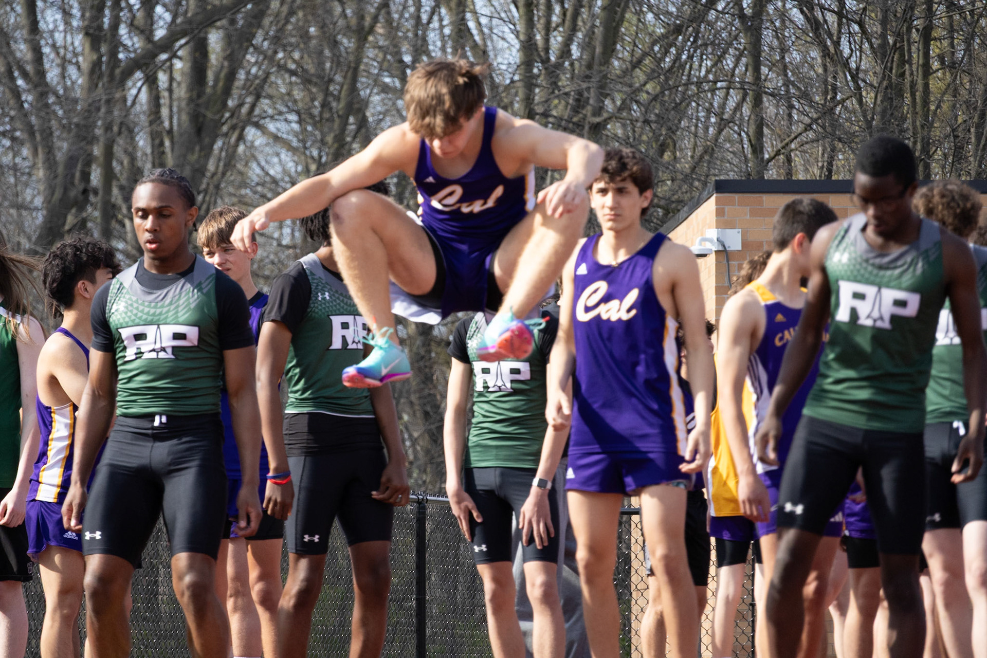 Connor Meyers jumps to get ready for the 100 meter dash. (Photo by Abigail Douglass)
