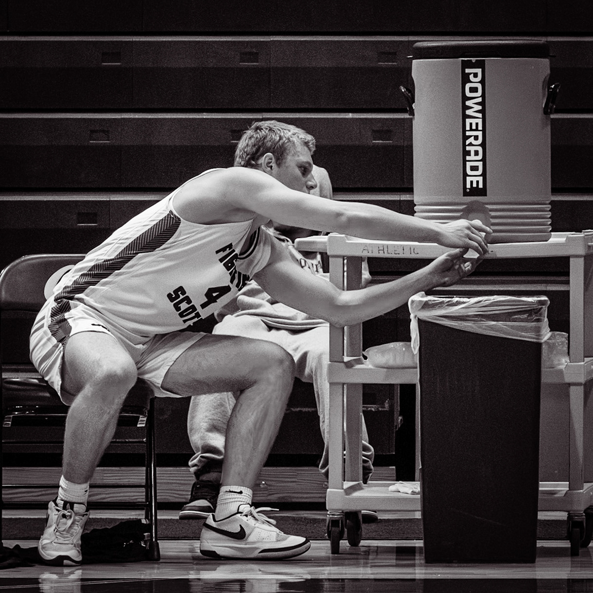 After a tough first peroid against Jenison, Logan Uyl reaches for drink. (Photo by Adi Malvankar)