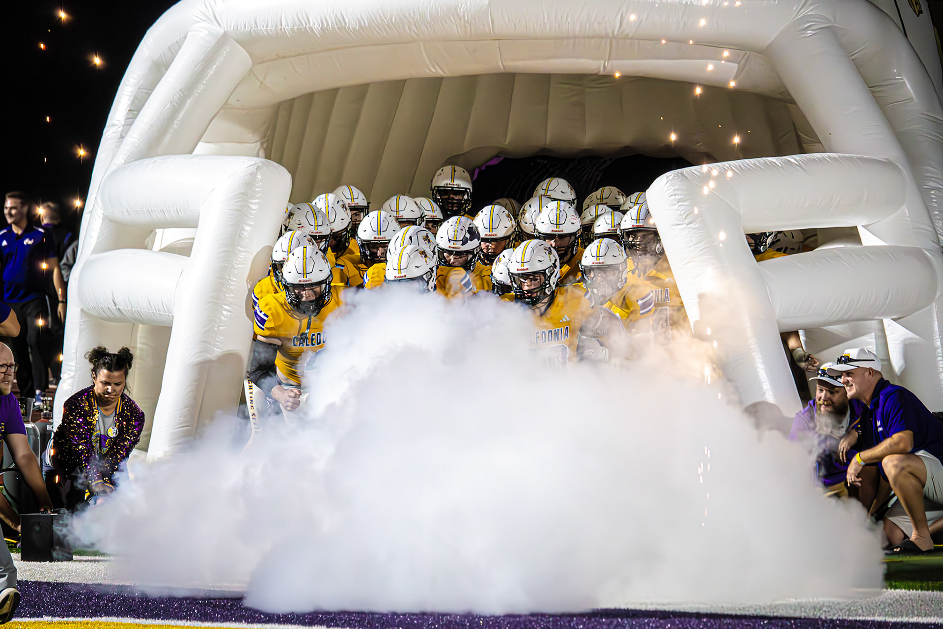 BACK TO WORK  The Caledonia Scots burst out of the tunnel at halftime of the Homecoming game, ready to finish strong. (Photo by Egan Otto)