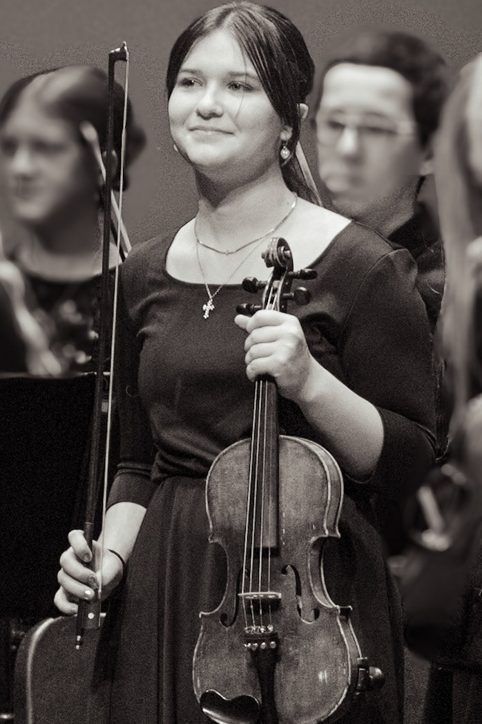 Freshman Felicity Fanco celebrates her performance in the orchestra concert.(Photo by Ollie Fox)