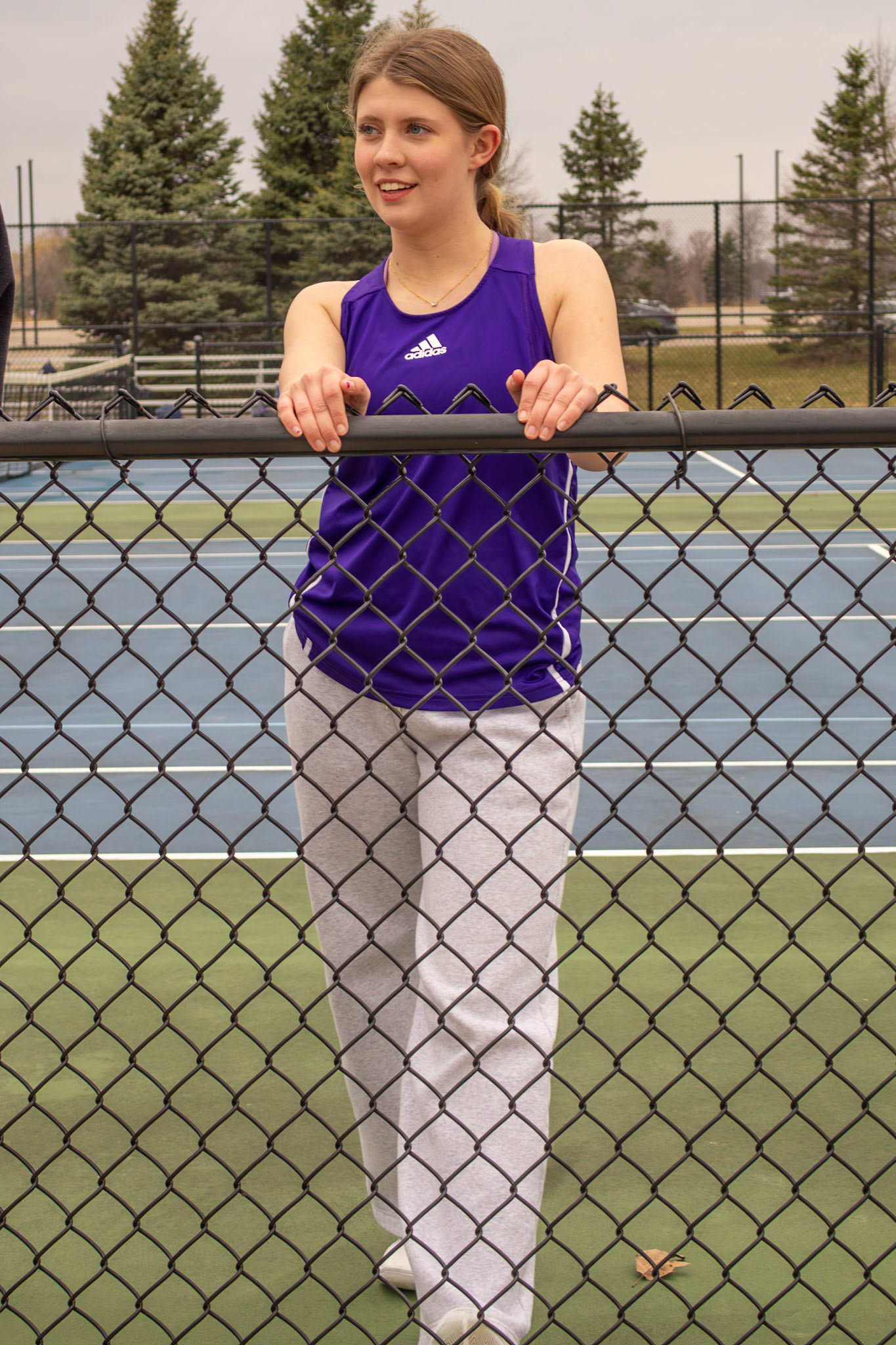 Madison Reynold stretches at JV tennis practice after a weather-related cancellation. (Photo by Ava LaBine)