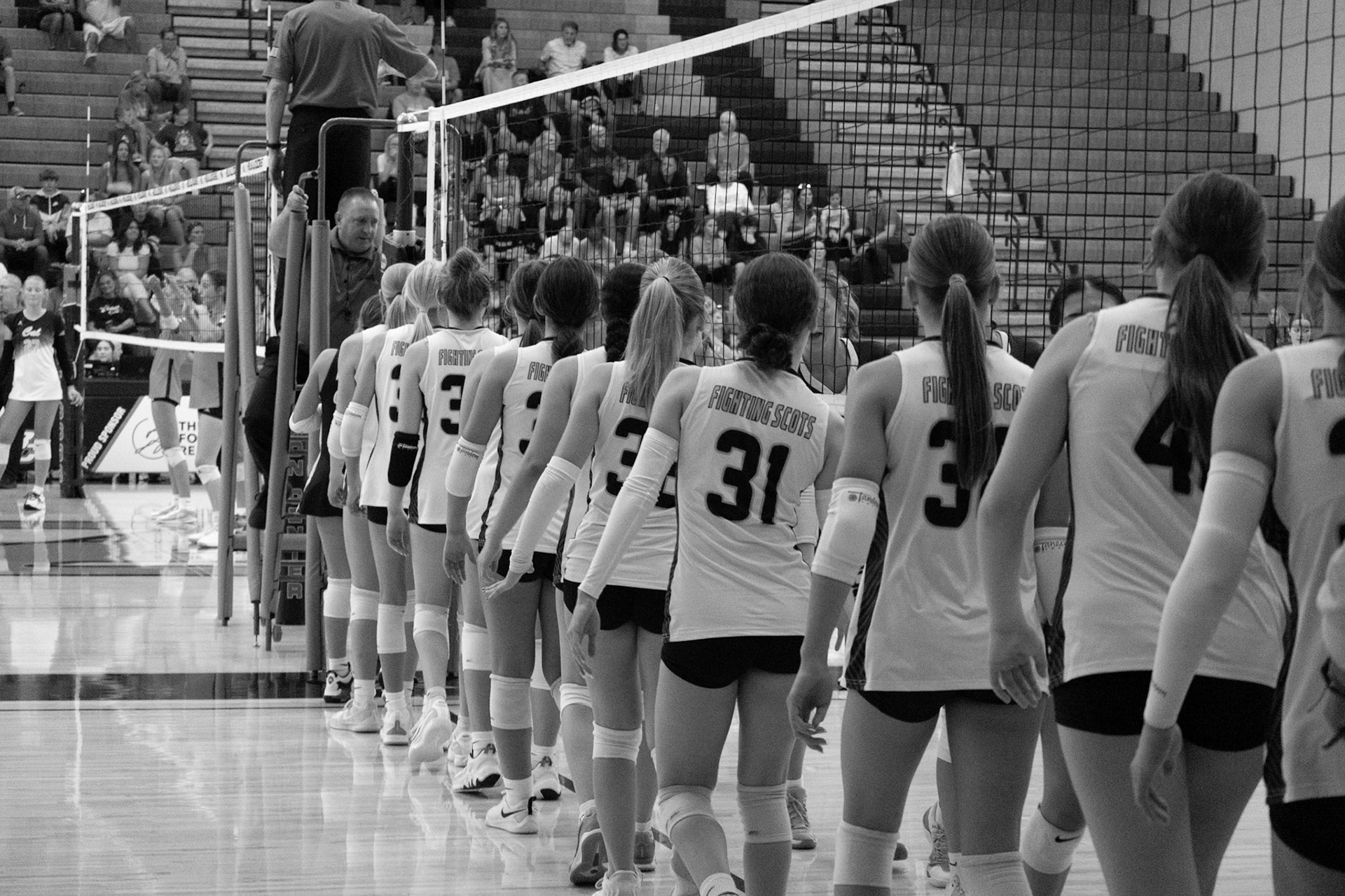 The freshman volleyball team shows sportsmanship by congratulating Byron Center after the game.