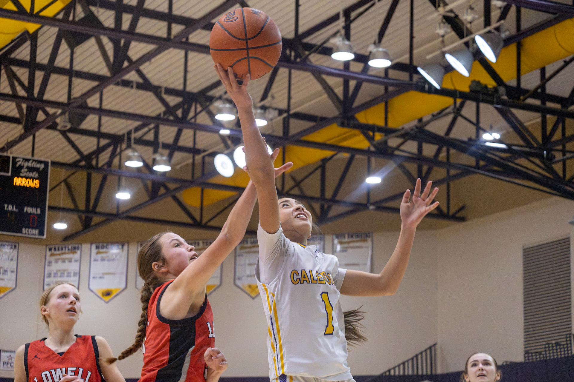 Braylee Tep attacks the basket during a contested play against Lowell. (Photo by Landry Mueller)