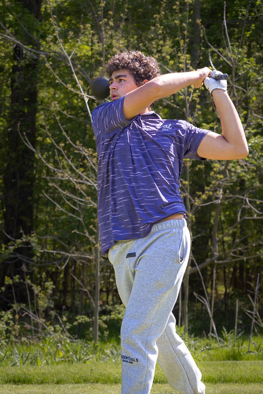Jackson Heffner finishes a strong drive with a confident follow-through. (Photo by Emma Garza)
