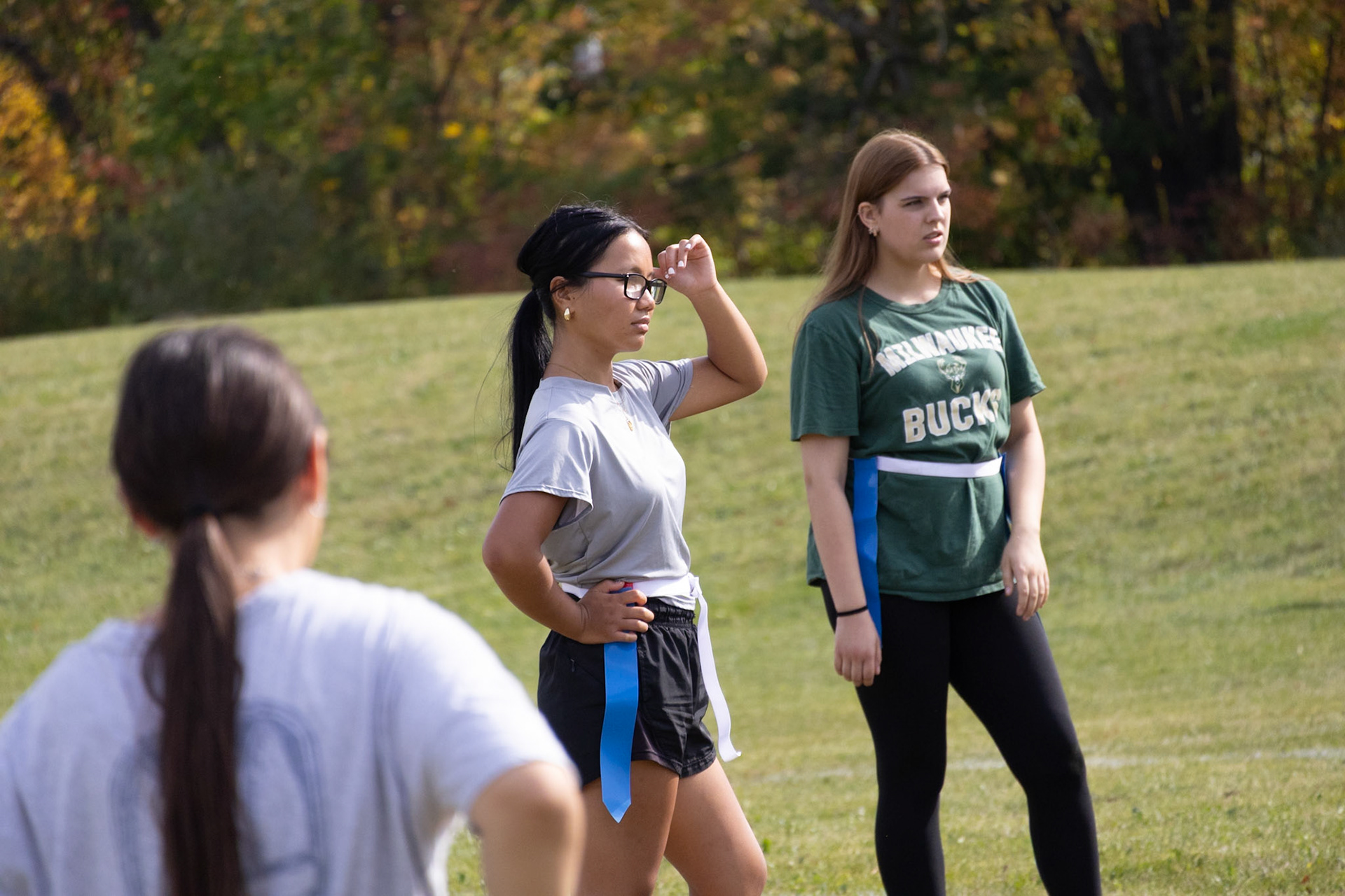 POWDERPUFF PRACTICE While the coaches explain the next play, Angel and Sophie listen while Juju stares them down. (Photo by Jaren King)