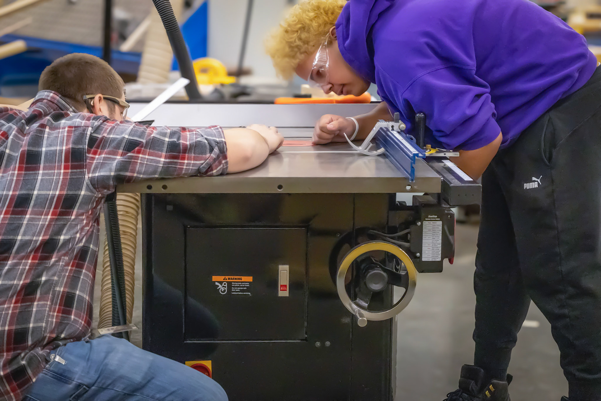 FOCUSED Isaiyah Supuk and Mr. Scholten work together on the table saw in Advanced Woodworking. (Photo by Natalia Teneyuque)