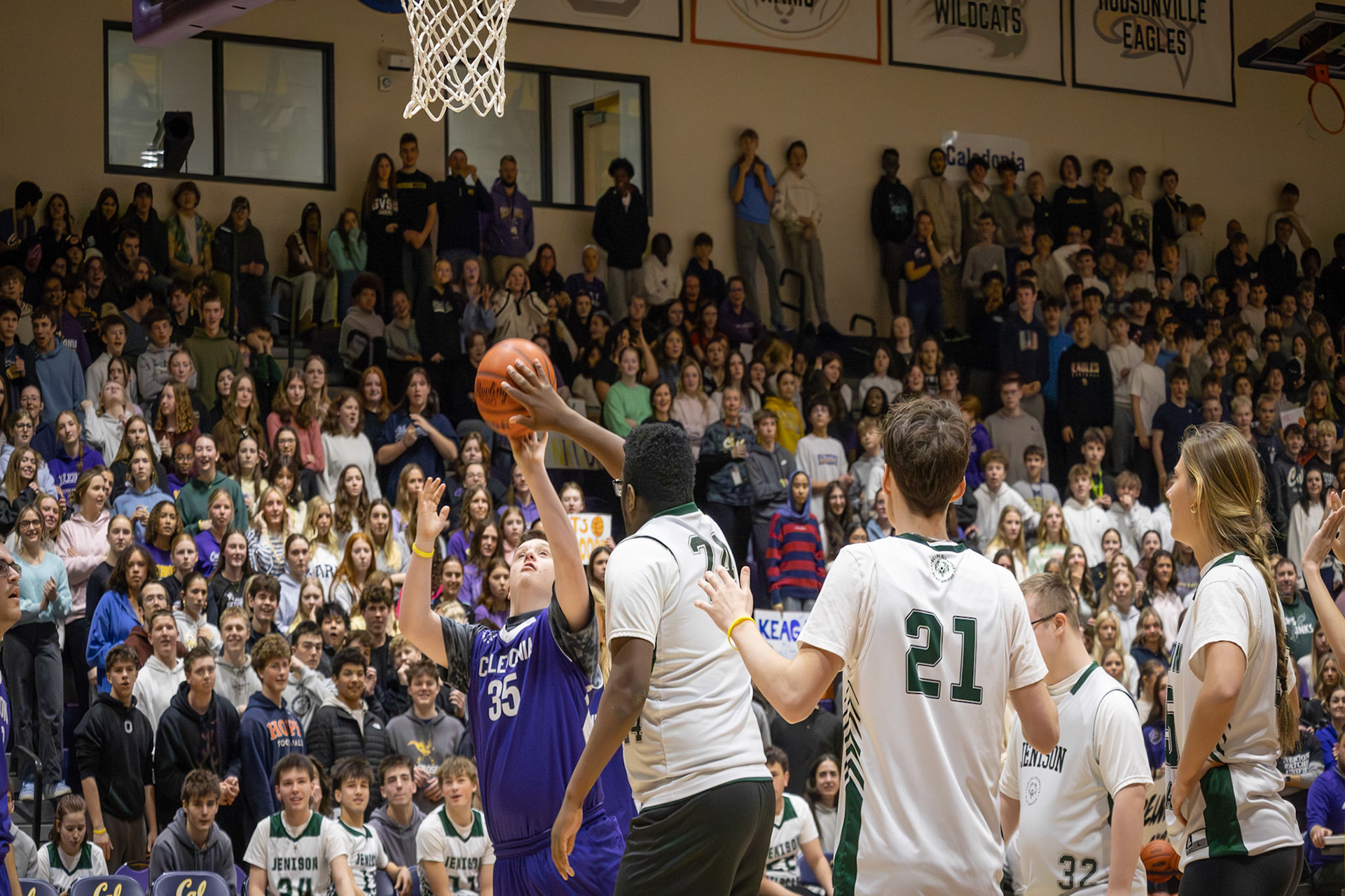 Caleb Helmholdt goes up for a shot but is blocked by a Jenison Unified player, stopping the play mid-attempt. (Photo by Abby Skibinski)