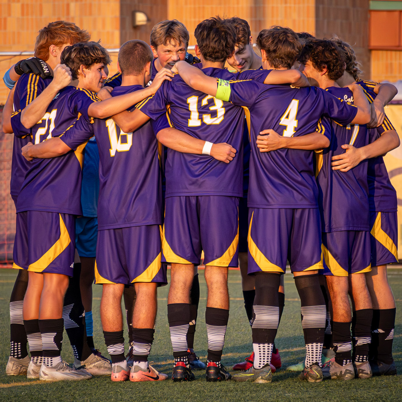 In an energetic pregame huddle, the Fighting Scots pump each other up and prepare to take the field. (Photo by Milana Rico)