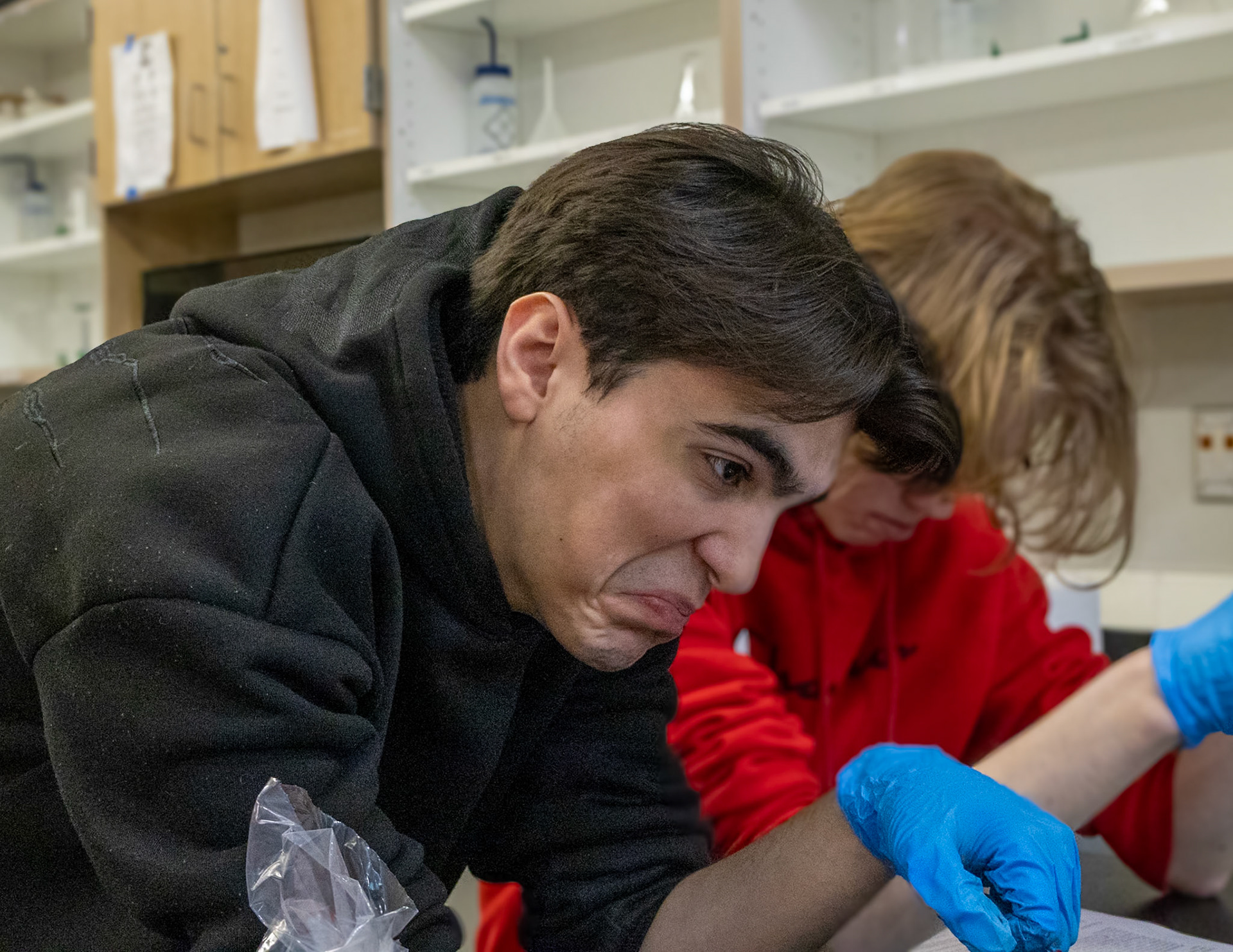 Senior Ryan Snider reacts with visible disgust while examining a pig heart prepared for dissection. (Photo by Avarey Lippert)