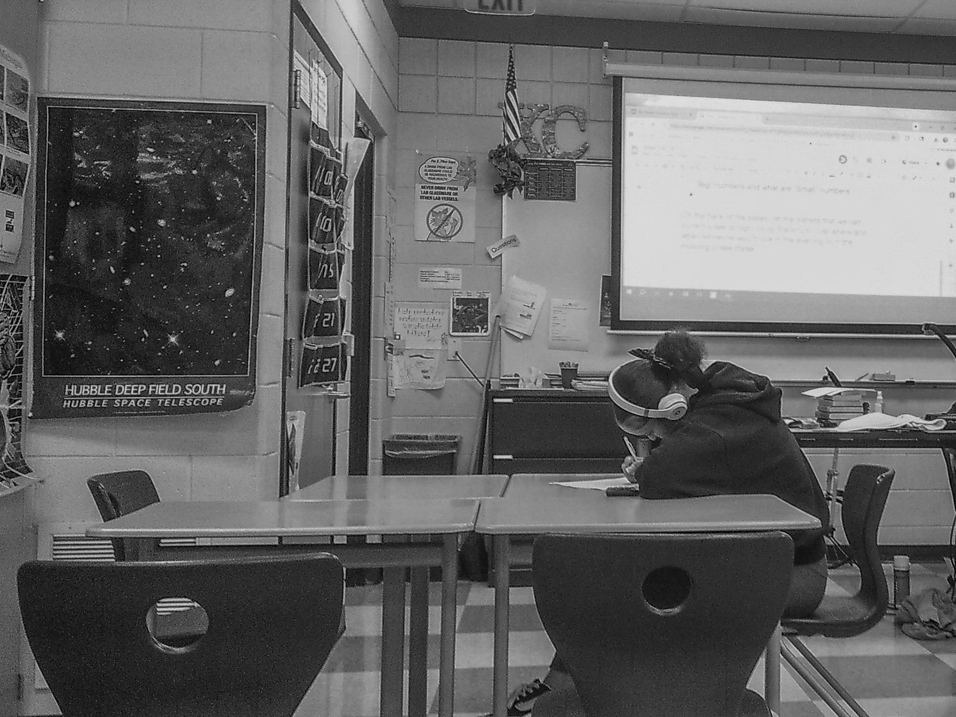 A student works on chemistry homework during seminar while listening to music. (Photo by Abby Skibinski)