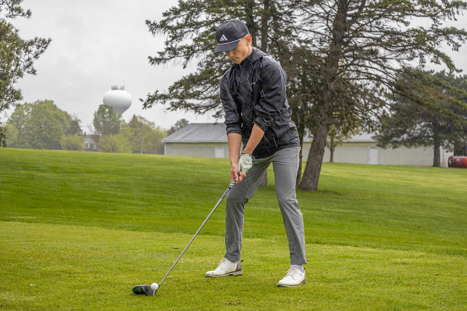 Standing out in the rain, Anderson Collins makes his only focus hitting the ball. (Photo by Emma Garza)