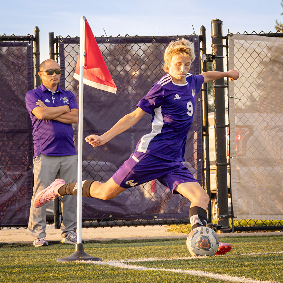 Kobe Buchan winds up to take the corner kick as our Athletic Director Mr. Miedema assesses the play. (Photo by Rhyan Guzman)