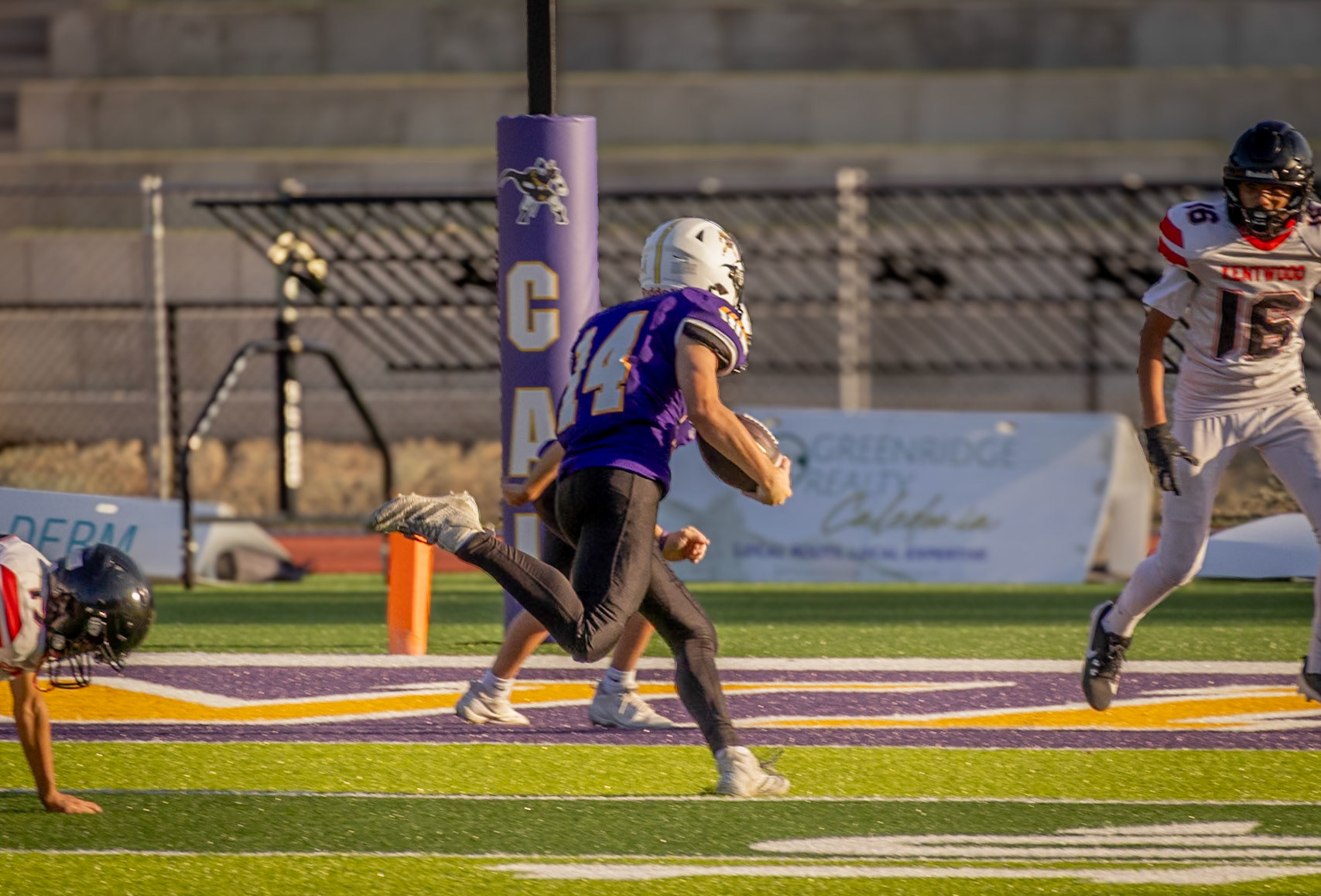 Clayton Paggeot dodges East Kentwood’s defense on his way to the end zone. (Photo by Ella-Grace Wickens)