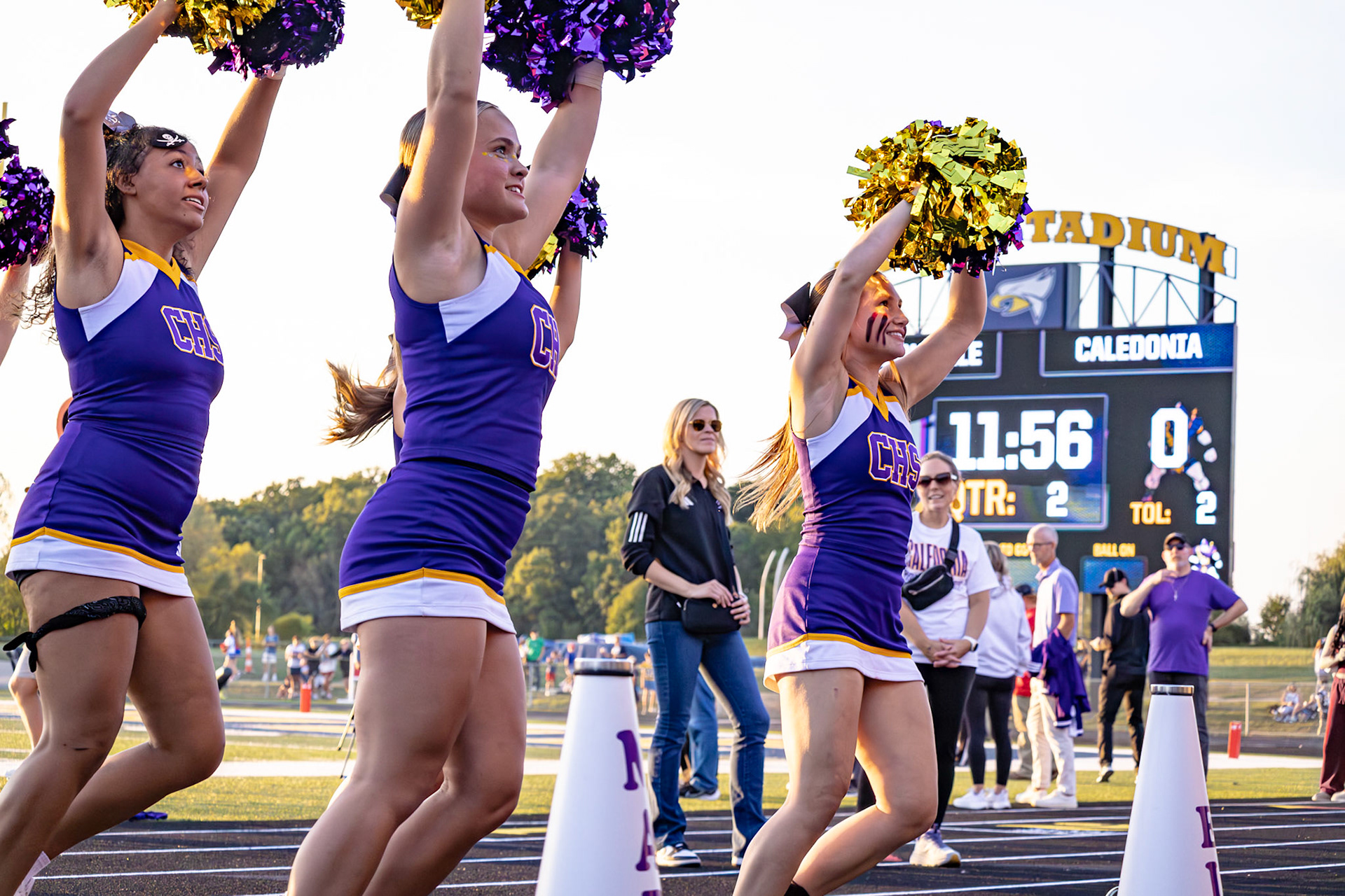 In perfect sync, Ella Wickens, Mariah Peterson, and Shelyn Thomas-Ferrell light up the sidelines at Hudsonville with their energy and teamwork. (Photo by Lillian Jackson)