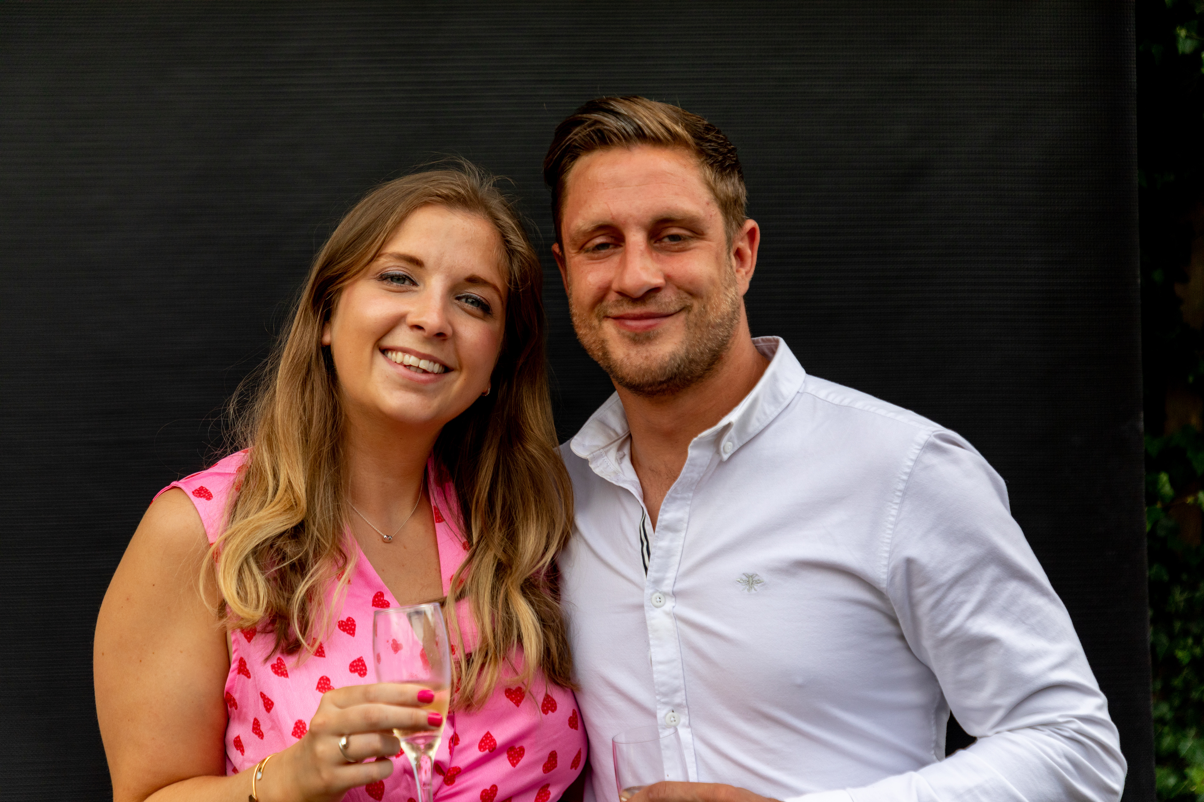 A couple, formally dressed on a black studio background