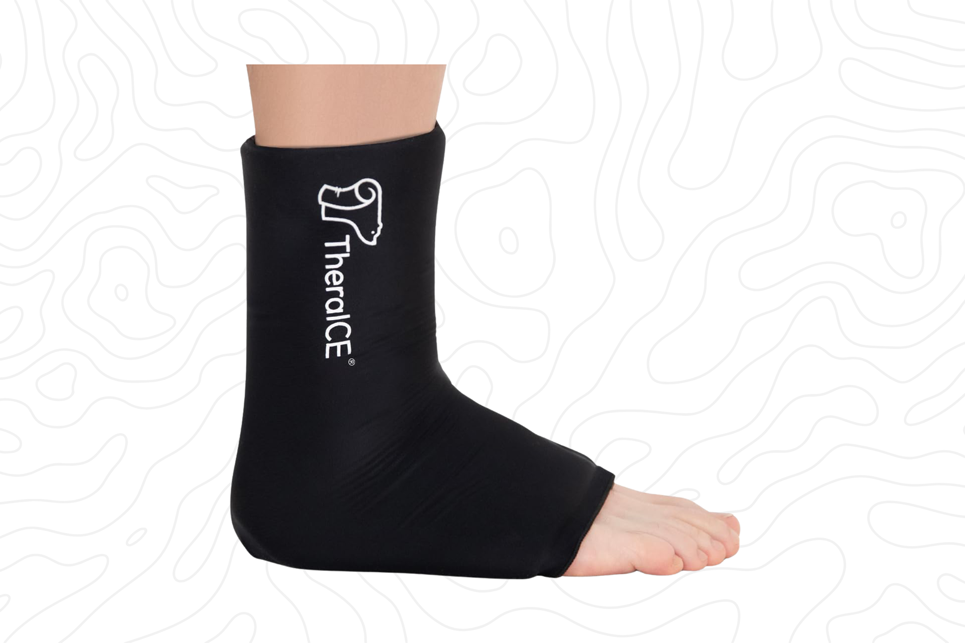 A black ankle ice pack wrap fitted around a person's foot and ankle.