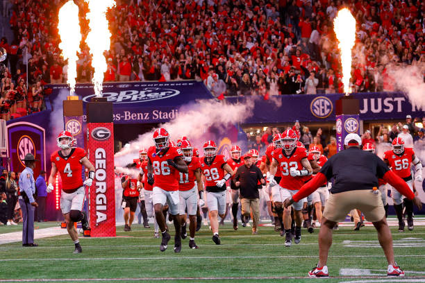 Branded tunnel takeover at kickoff — custom team signage, sponsor elements, and quadfold displays shown during player entrances.