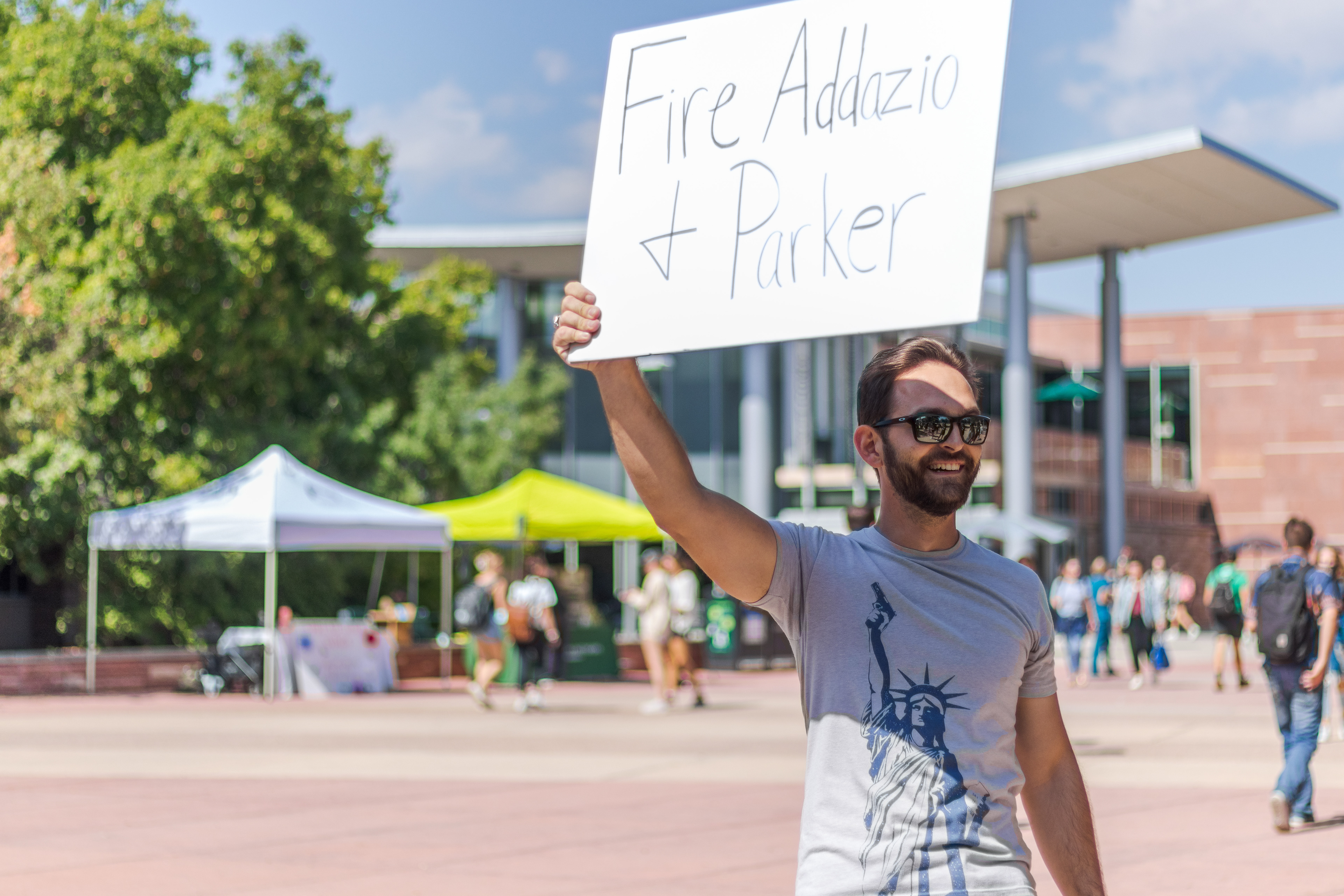 Kevin Larusso holds a sign saying "Fire Addazio + Parker" on the Lory Student Center Plaza at Colorado State University Sep. 14. "It is an absolute embarrassment that after Mike Bobo was fired for an underperforming team that was not able to put any excitement out there, they went and hired the literal worst possible option," said Larusso. "The guy has no idea what he's doing out there and that is very obvious."