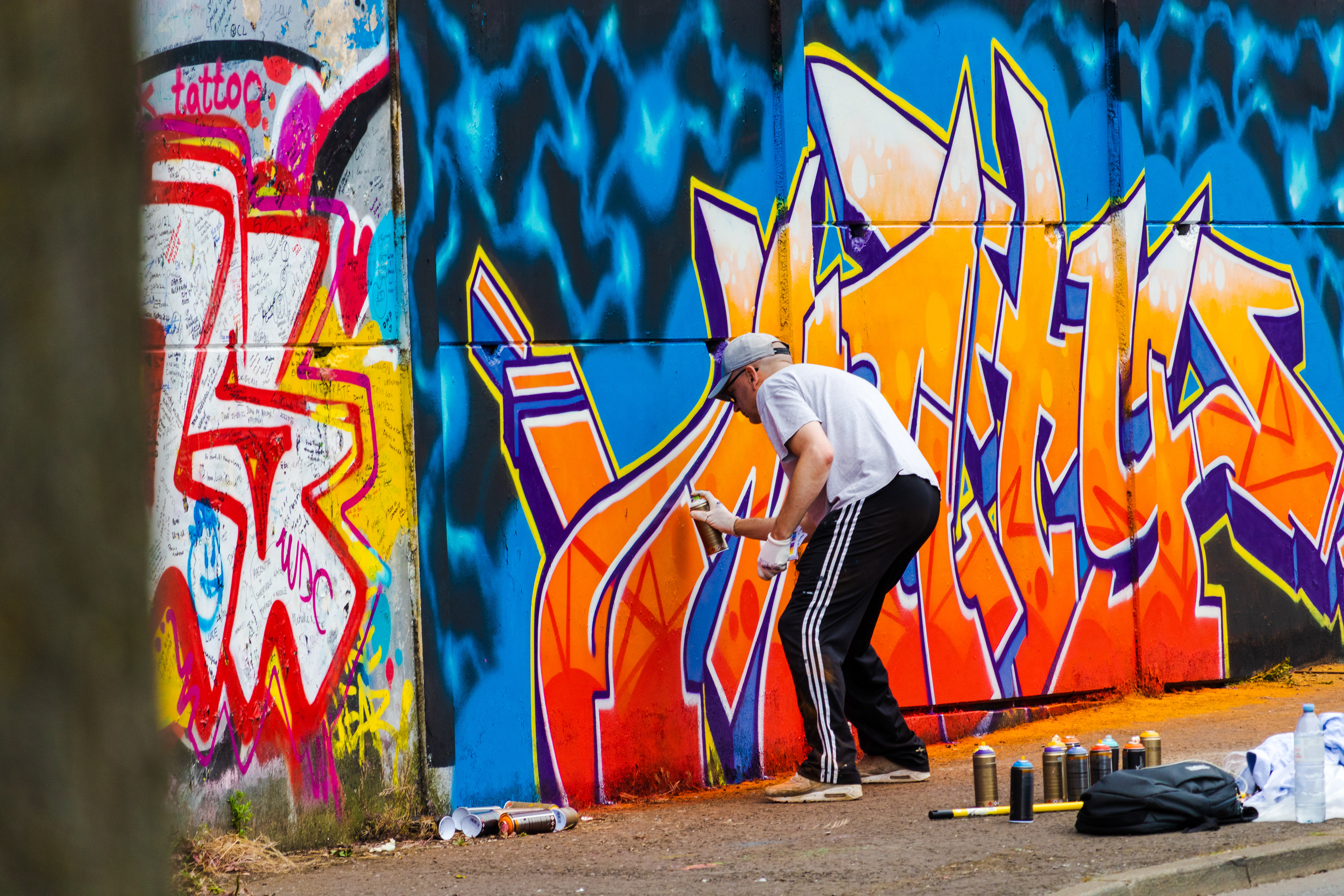 A man spray paints a section of the Belfast Peace Wall June 16. Constructed in the 1970s in an attempt to control violence between Belfast's primarily Catholic republican neighborhoods and its primarily Protestant loyalist neighborhoods, the peace wall is covered in messages of peace, love, and hope left by people visiting from around the world.