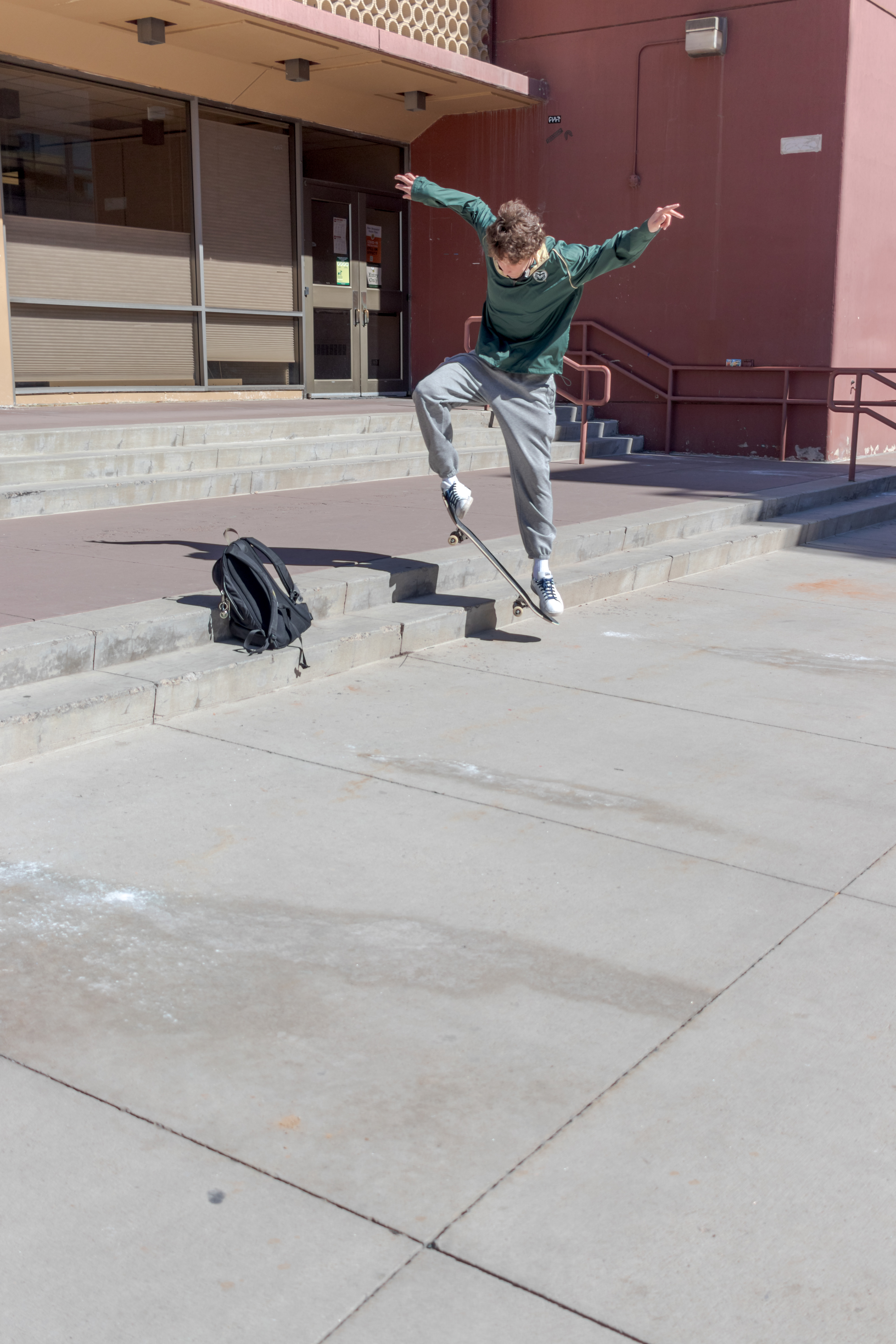 Sebastian Griffin practices landing a trick on his skateboard outside the Clark building, Mar. 3. Originally from Boulder, Colorado, Griffin came to Fort Collins for Colorado State University's Agricultural Sciences program. Griffin practiced his trick for "about thirty minutes... it requires you balancing on your back wheels so it's kind of hard," he said.
