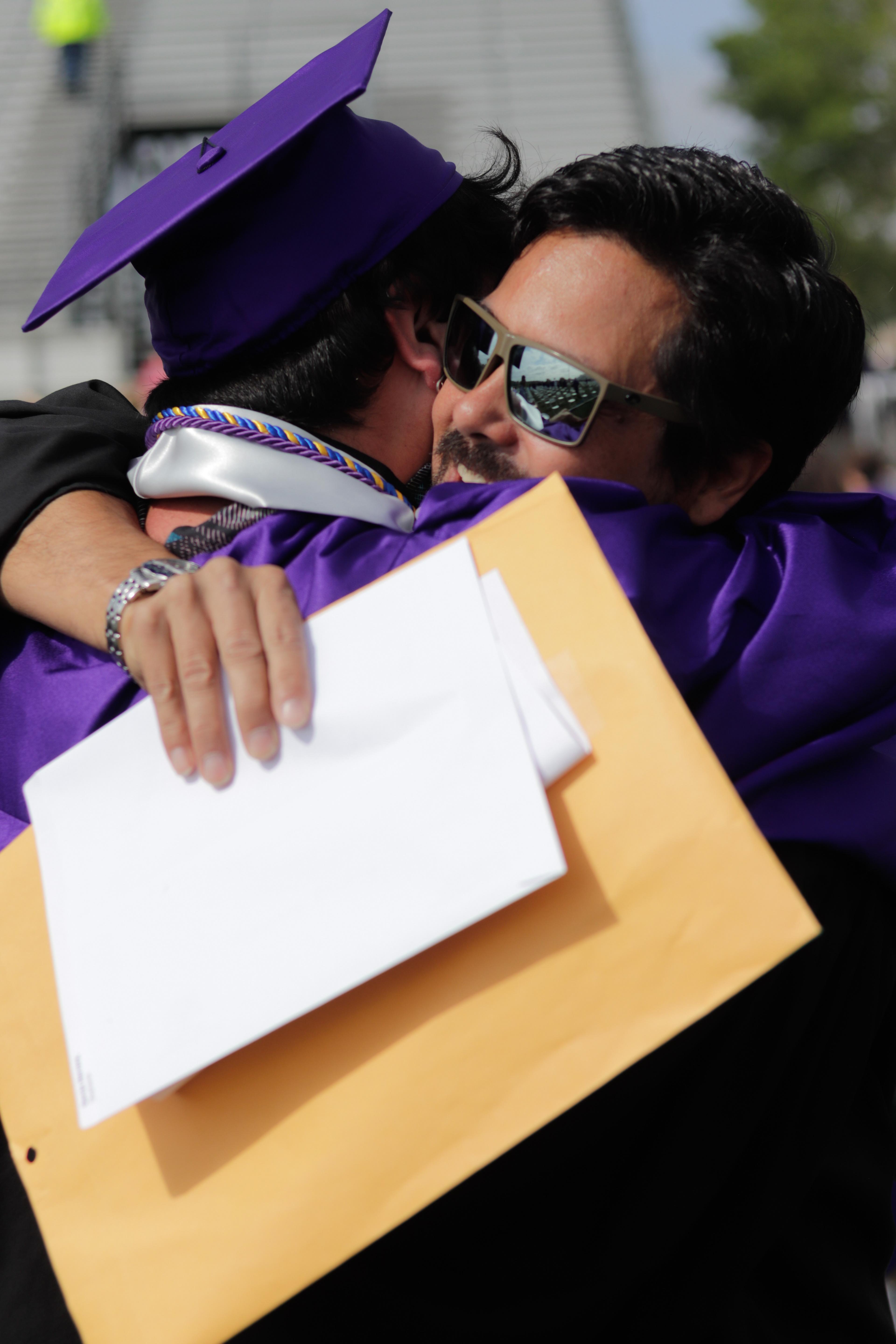 LOVELAND, CO - MAY 29, 2021: Mountain View graduate Alex Pannone hugs Language Arts teacher Matt Hall after his graduation ceremony Saturday, May 29, 2021 at Patterson Field in Loveland. (Michael Marquardt/Loveland Reporter-Herald)