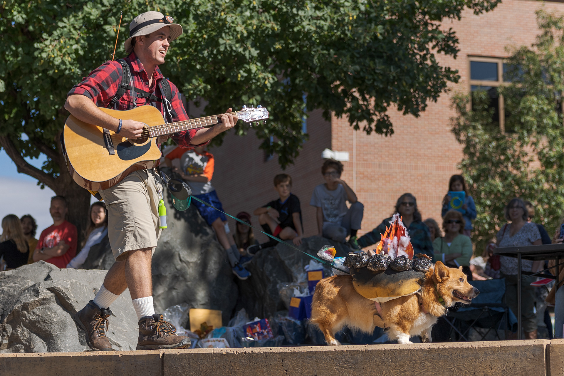 Former Associated Students of Colorado State University President Christian Dykson walks his corgi, Cody, across the stage during the Tour de Corgi costume contest Oct. 1. "It's one of the most unique traditions in the entire country," Dykson said. "What other community brings corgis from all around the state and country to do stuff like this?"