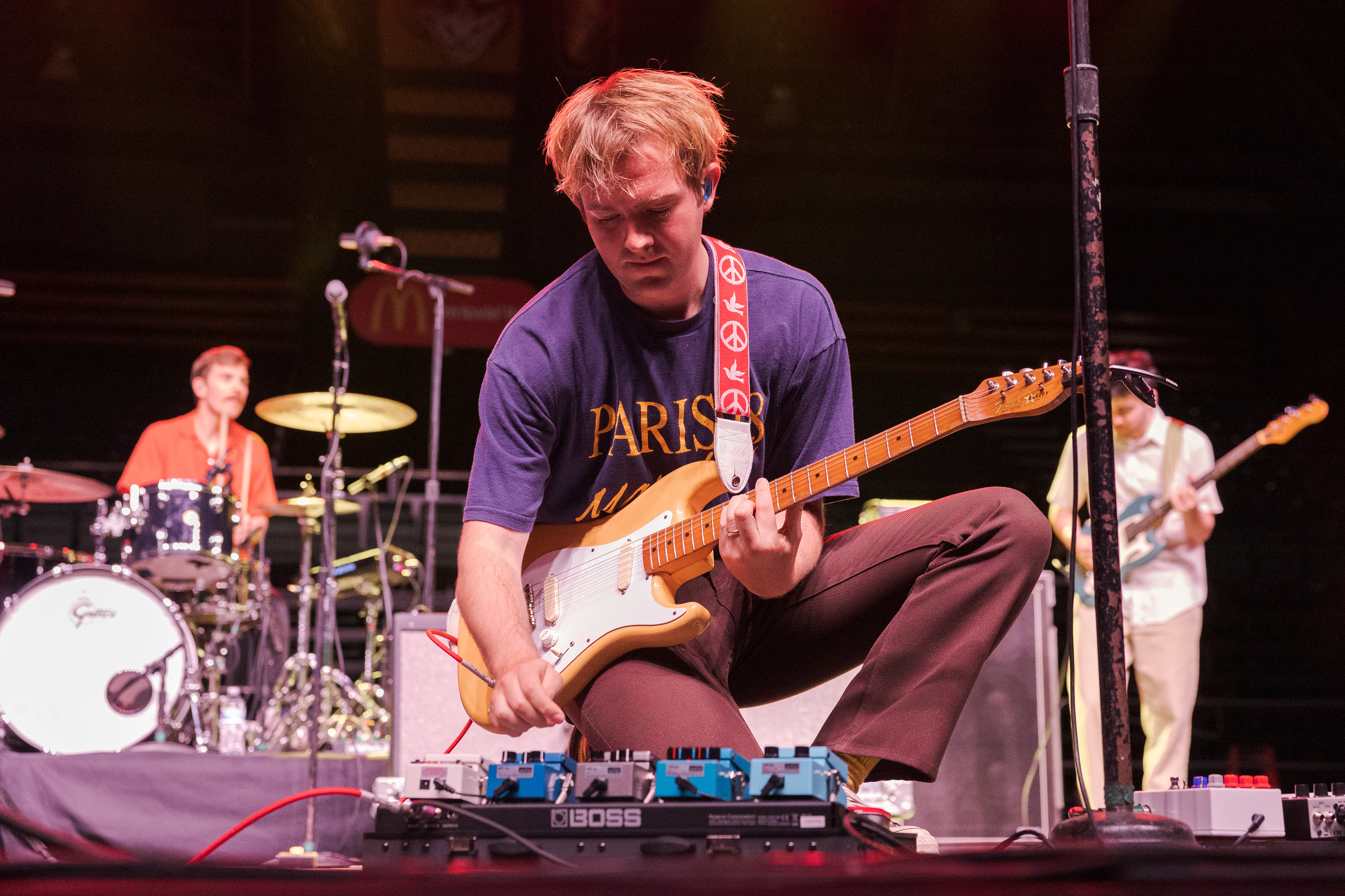 Sloan Struble of Dayglow adjusts a guitar pedal between songs during RamFest at Moby Arena April 27. In the studio, Struble writes and records parts for each instrument in Dayglow's songs.
