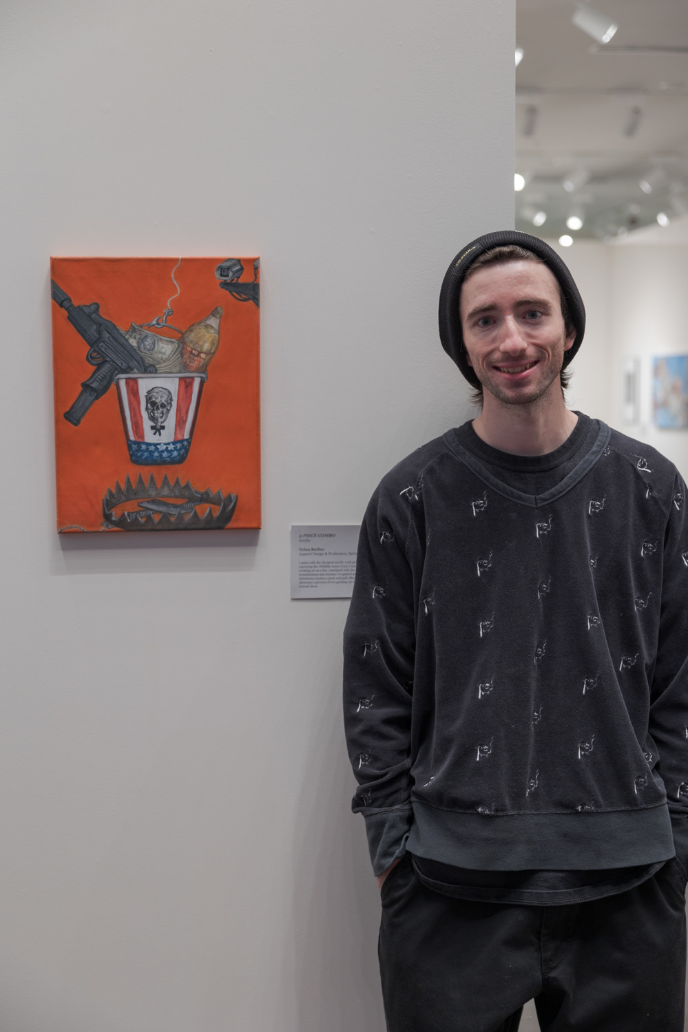 Dylan Barber shares his painting, "3-Piece Combo", a the Colorado State University Student Art Exhibition Nov. 29. "To me it represents the lifestyle of poverty, growing up in poverty in America," Barber said. "The country dangles a lot of these things towards poor people. And we want them, we go for them — it’s a trap, though. I grew up homeless and painting and creating art is something that means a lot to me, so I'm trying to put that into the painting but also keep the childlike sense of creativity and passion for art that I had since I was a kid." When asked where this passion comes from, Barber shared stories from his childhood. “My Nana is an artist,” Barber said. “She's a brilliant artist, and I think it was passed down to me but also, my deepest memories, I think I was like four years old, and my grandpa was teaching me how to draw Bugs Bunny and Looney Tunes characters and I thought it was the most amazing thing. He could draw them perfectly in two minutes. It looked just like the cartoons and so as a kid that was something that was very inspiring.”