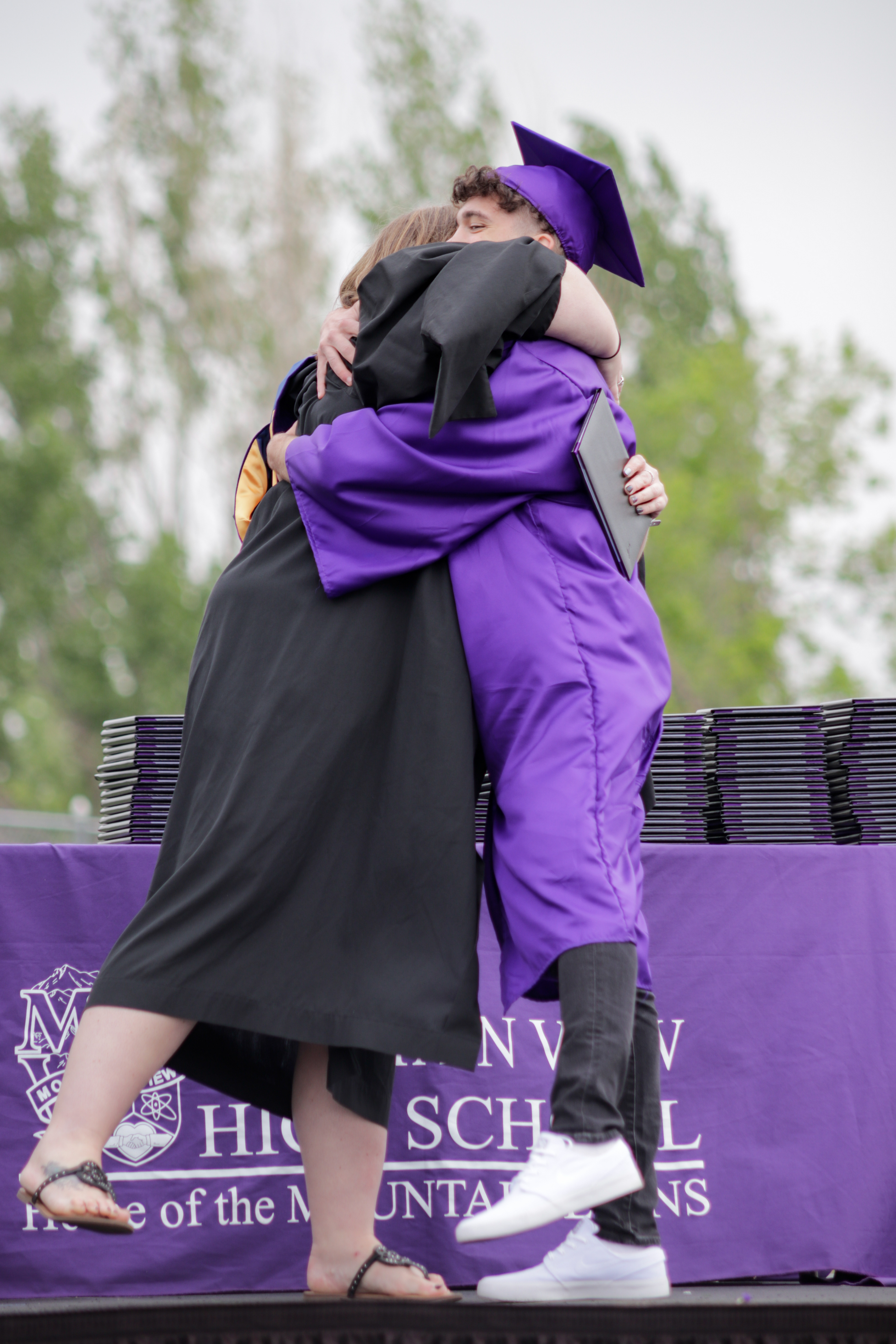 LOVELAND, CO - MAY 29, 2021: Mountain View graduate Corbin Reak hugs counselor Kelsey Rosten after receiving his diploma Saturday, May 29, 2021 at Patterson Field in Loveland. (Michael Marquardt/Loveland Reporter-Herald)
