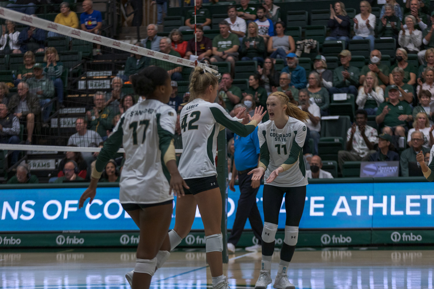 Colorado State University Outside Hitter Kennedy Stanford (17), Middle Blocker Karina Leber (42) and Setter Ciera Pritchard (11) celebrate after scoring against the University of Nevada, Reno Oct. 6, 2022. CSU won 3-0.