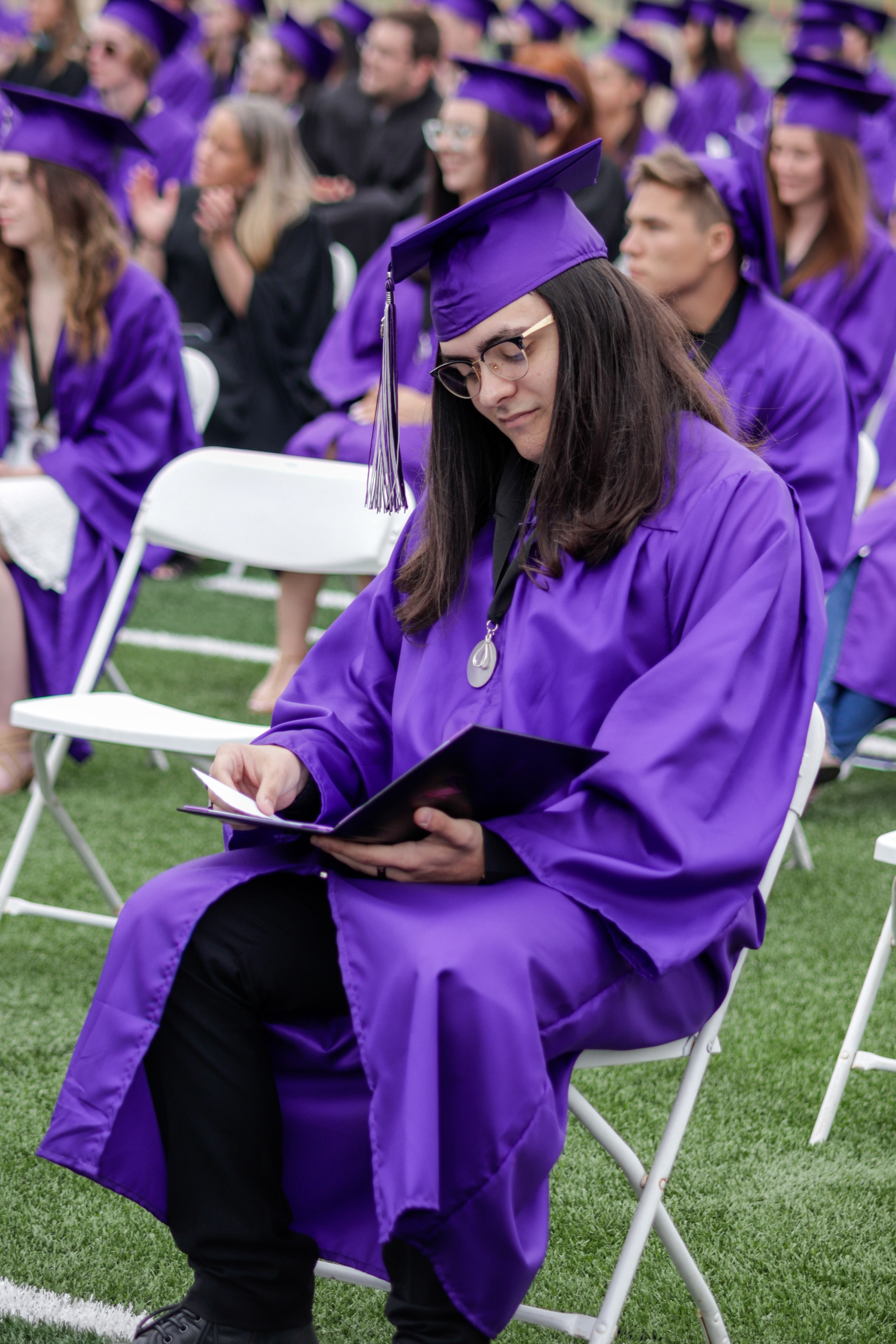 LOVELAND, CO - MAY 29, 2021: Mountain View graduate Jacob Sparks looks at his diploma during his graduation ceremony Saturday, May 29, 2021 at Patterson Field in Loveland. (Michael Marquardt/Loveland Reporter-Herald)