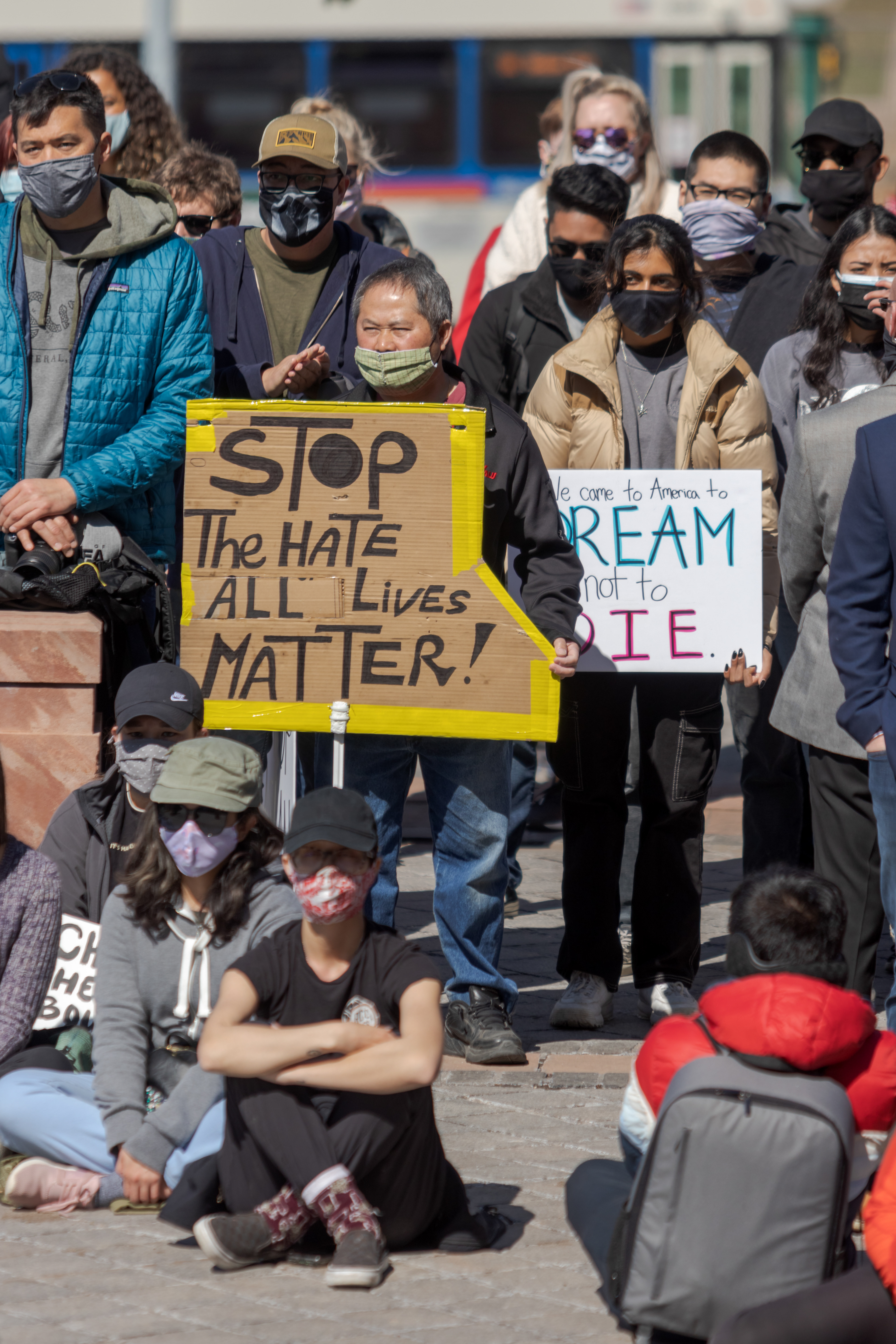 Protesters hold signs outside the Colorado State Capitol March 27. The protest featured speeches, poetry, and music from the Asian-American and Pacific Islander community.