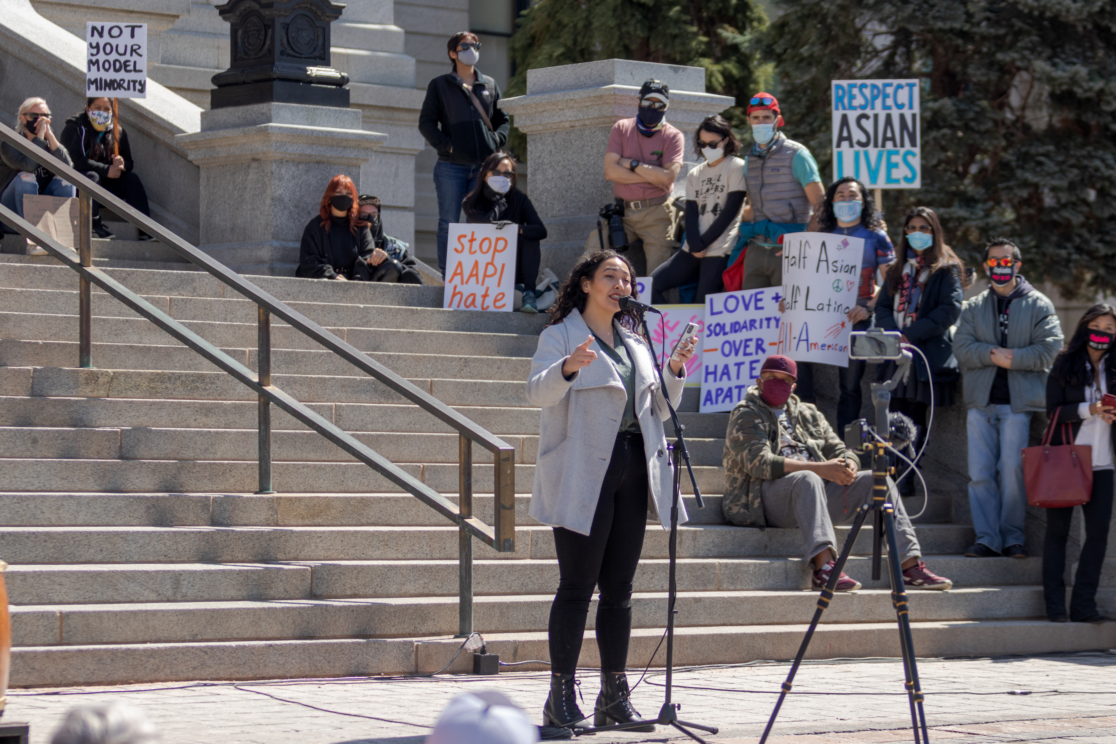 A woman performs her poem, "Model Minority", outside the Colorado State Capitol March 27. The poem recounted her experiences growing up as a member of the Asian-American and Pacific Islander community.