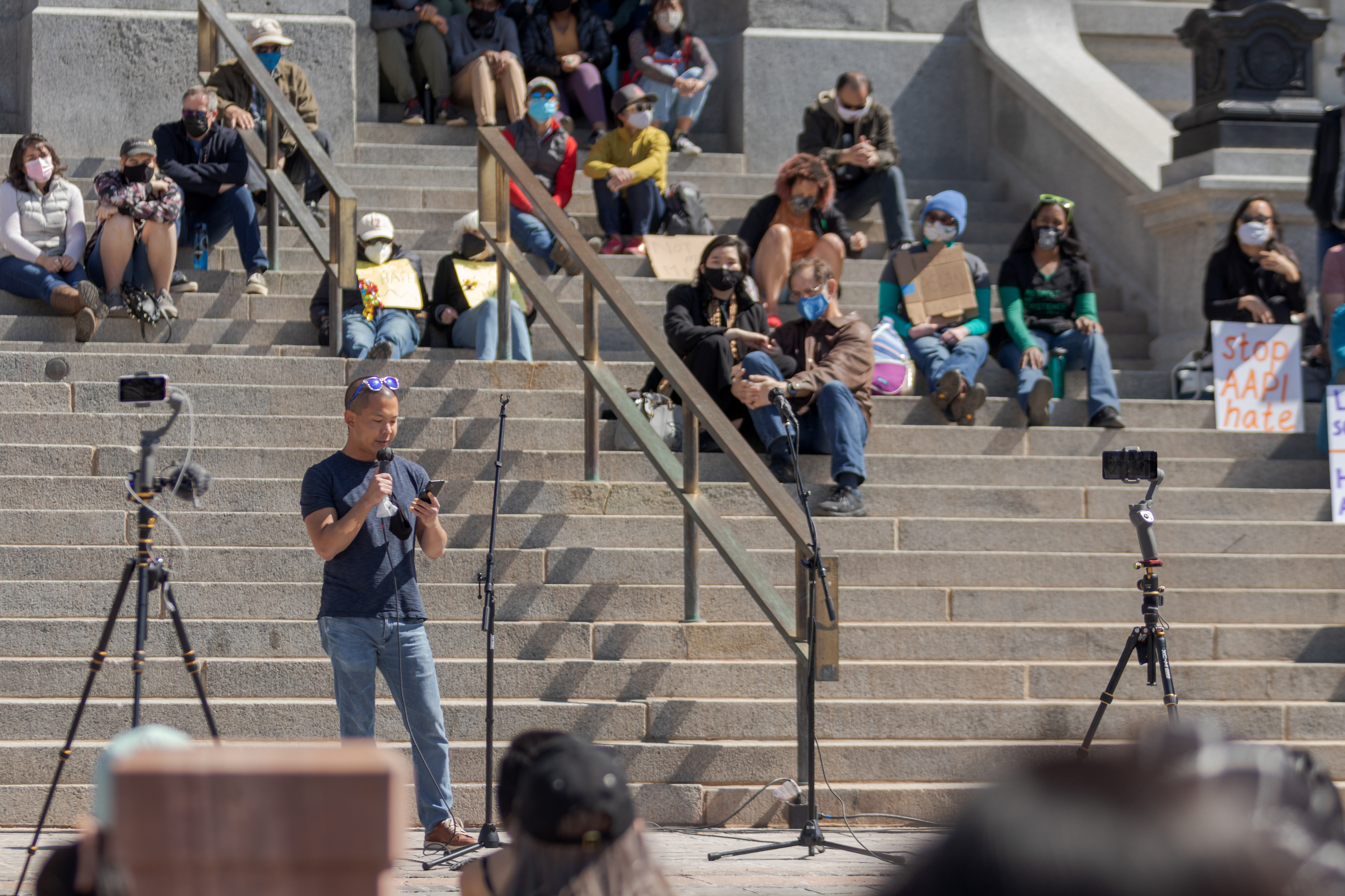 A man speaks to the crowd at a protest outside the Colorado State Capitol March 27. During his speech, he addressed stereotypes and called on the audience to "stop reading White" if they wished to better understand the challenges faced by Asian-Americans and Pacific Islanders.