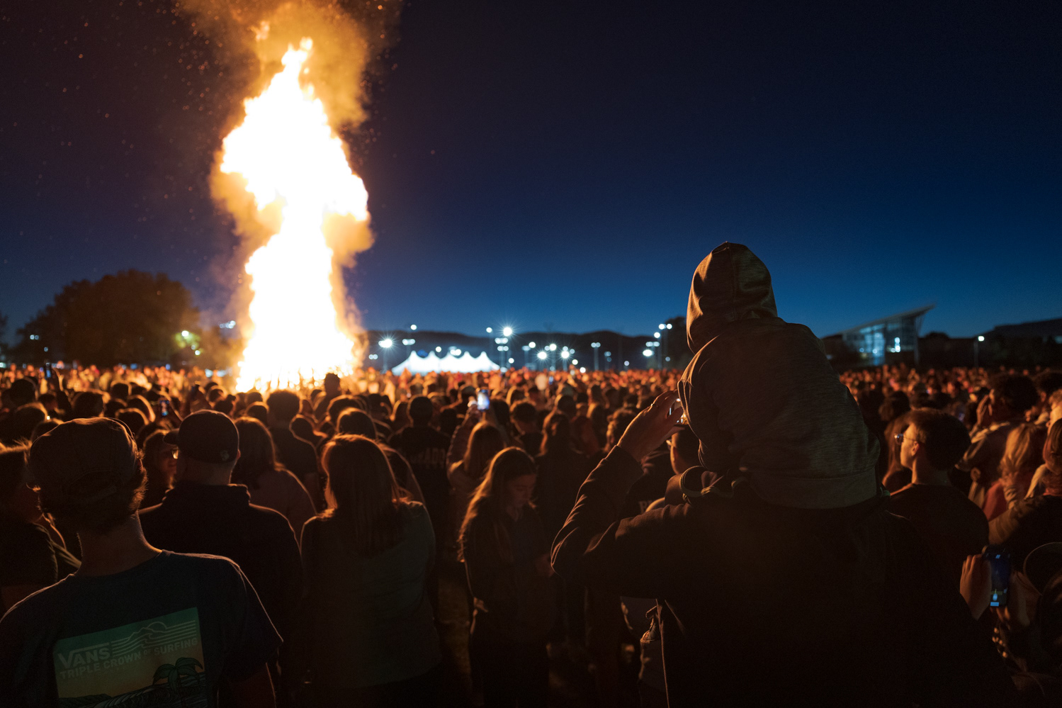 Colorado State University community members gather around a bonfire during Friday Night Lights Oct. 14, 2022.