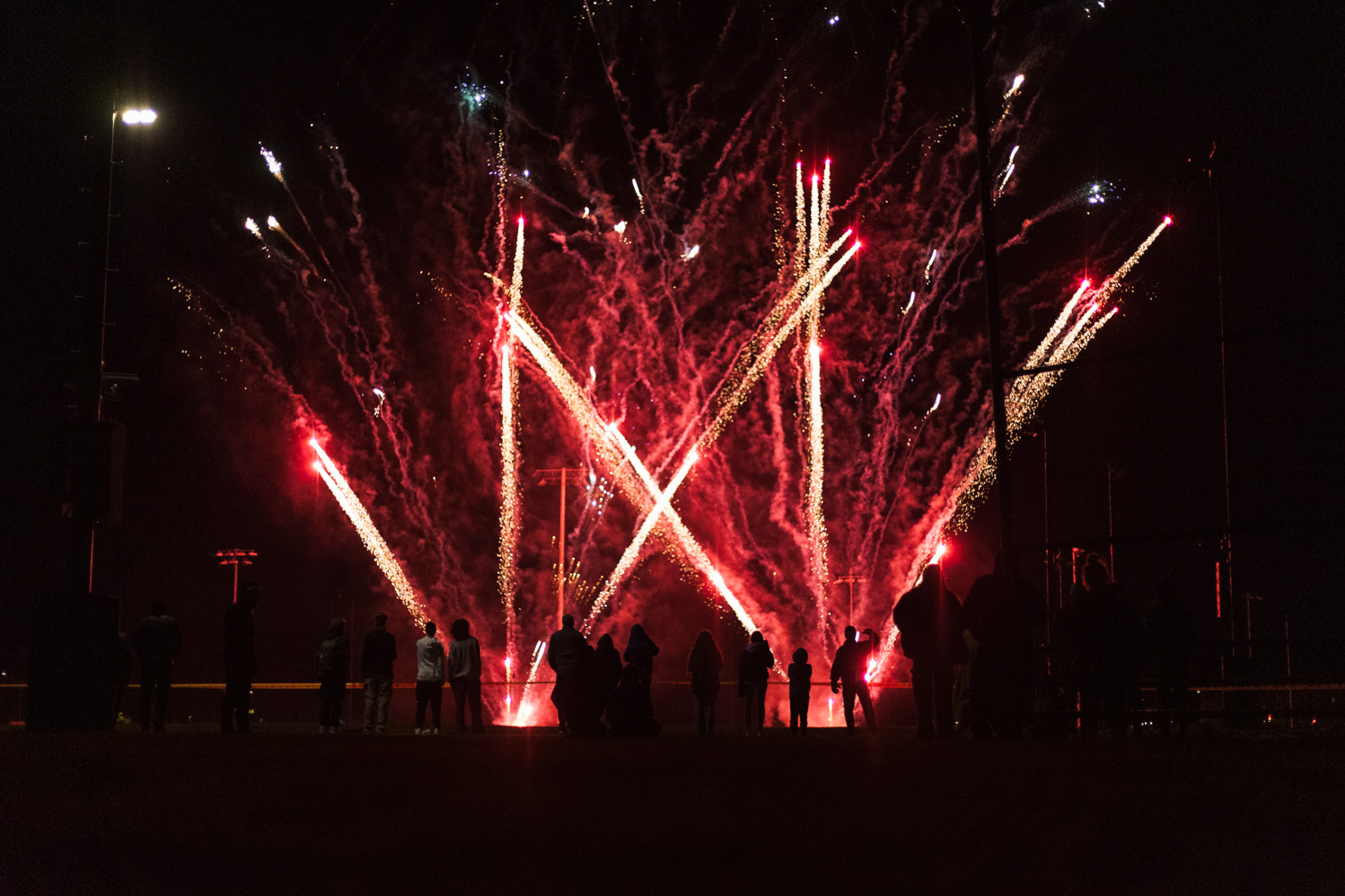 Colorado State University community members watch a fireworks show on the Intramural Fields during Friday Night Lights Oct. 13. Part of CSU's homecoming celebration, the event features performances from the marching band, color guard and cheerleaders, as well as speeches from sports coaches, a bonfire, fireworks and a DJ performance.