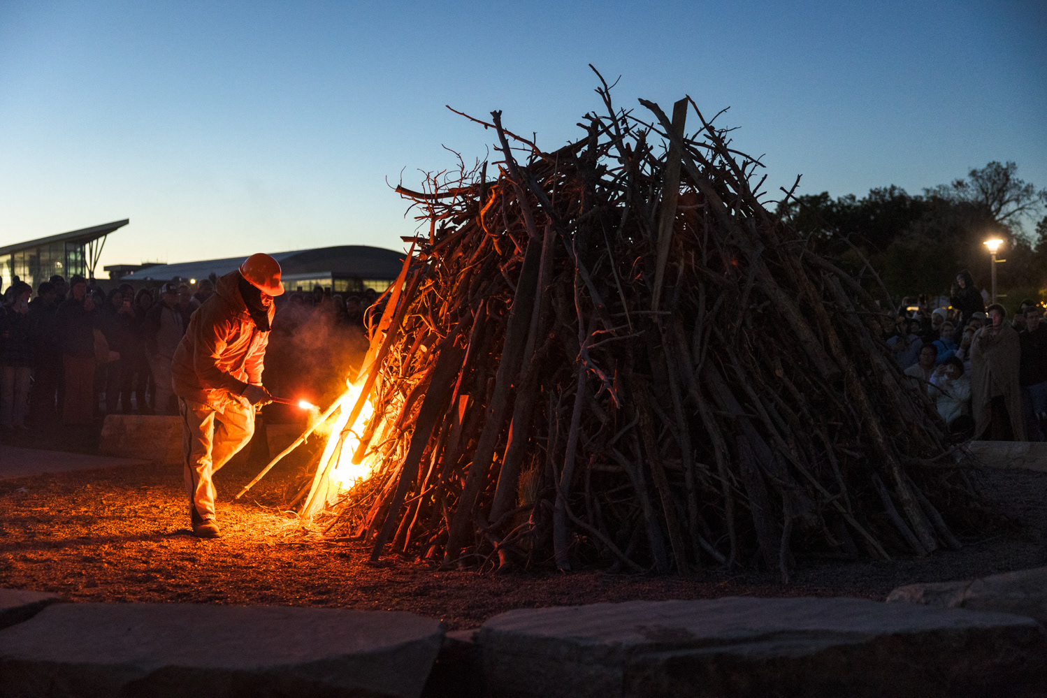 A member of the Colorado State Forest Service lights the bonfire at Colorado State University's Friday Night Lights Oct. 13. Part of CSU's homecoming celebration, the event features performances from the marching band, color guard and cheerleaders, as well as speeches from sports coaches, a bonfire, fireworks and a DJ performance.