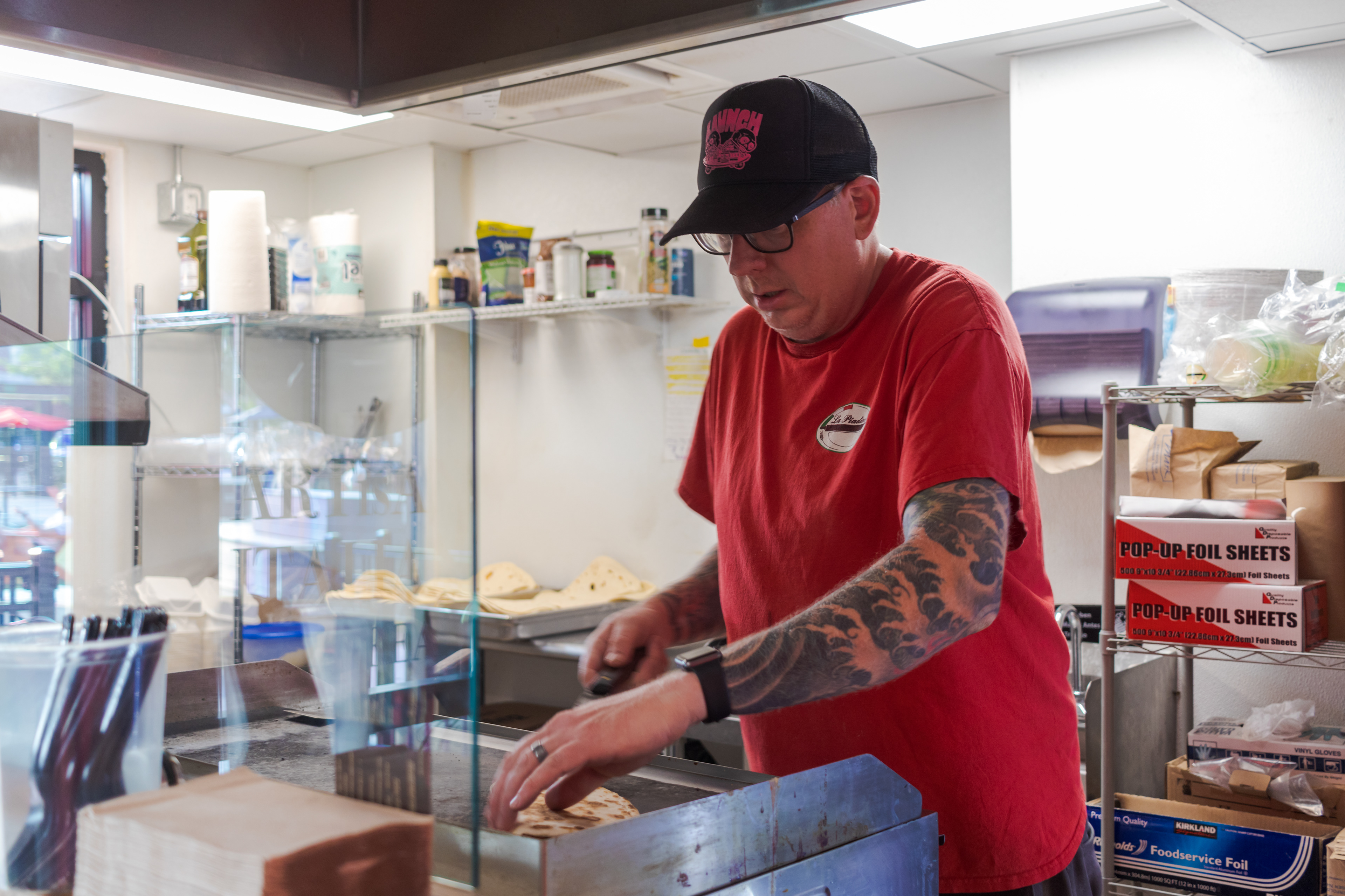 Nate Clark works at La Piadina August 5. La Piadina claims to be Fort Collins' smallest restaurant, occupying a repurposed shipping container in The Exchange, and serves Italian street food using a recipe dating back to 1371.