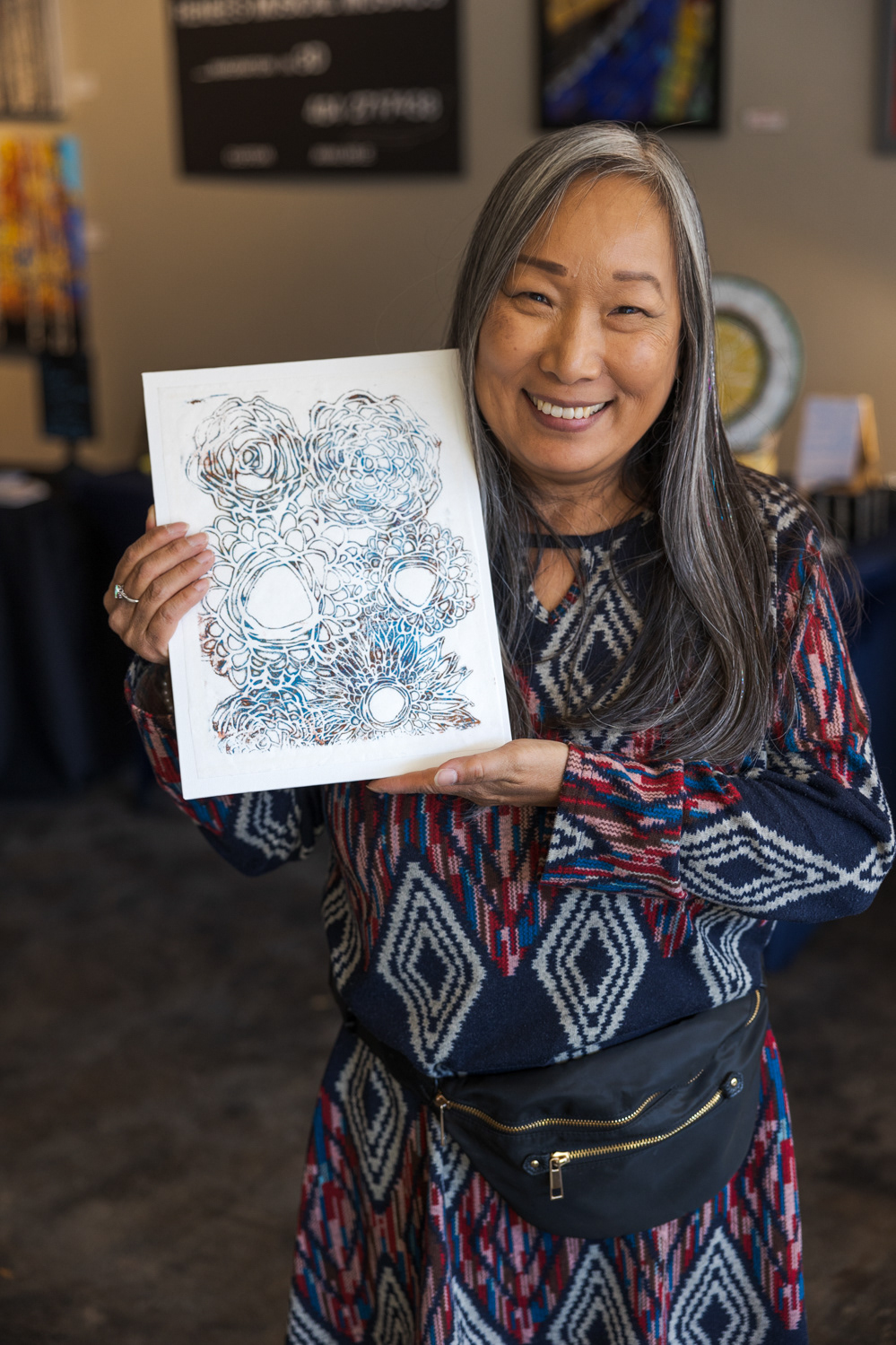 Ann Baron poses with her artwork at the Local Women Artists Market at Art Lab Nov. 5. "I've always enjoyed doing creative things," Baron said. "Even as a child I would sew and cook, take pottery classes, painting classes, and then the last few years really focus more on the mixed media greeting cards. A friend of mine, Renee, and I decided to do this together, invite other local women artists to participate, and really just share the love of art and creativity with the public."