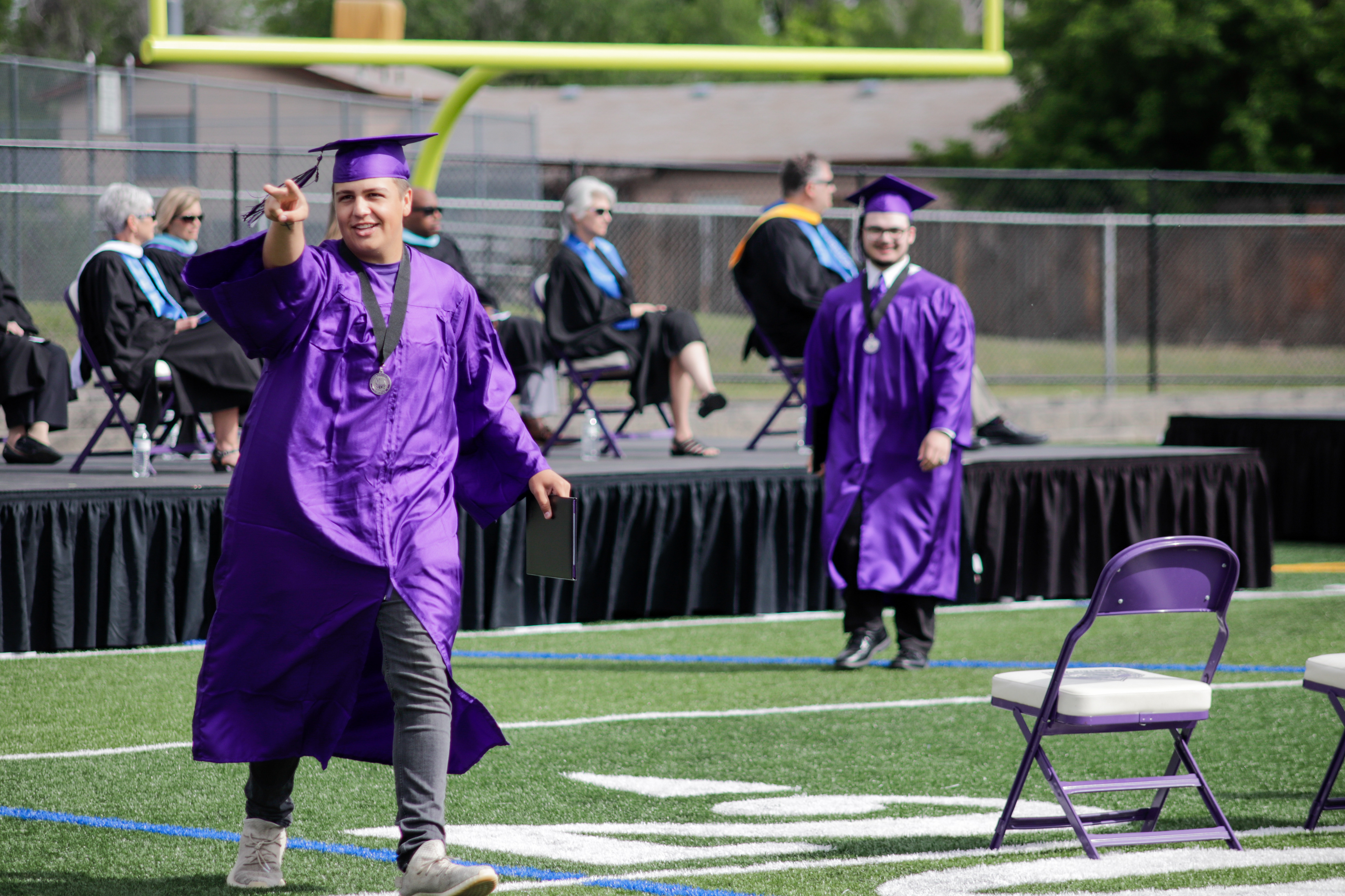 LOVELAND, CO - MAY 29, 2021: Mountain View graduate Grant Vander Hamm points to family members after receiving his diploma Saturday, May 29, 2021 at Patterson Field in Loveland. (Michael Marquardt/Loveland Reporter-Herald)