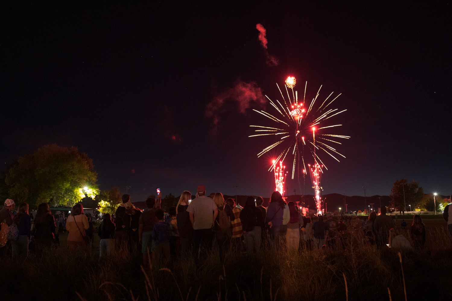 Colorado State University community members watch as fireworks are launched from the intramural fields during Friday Night Lights Oct. 14, 2022.