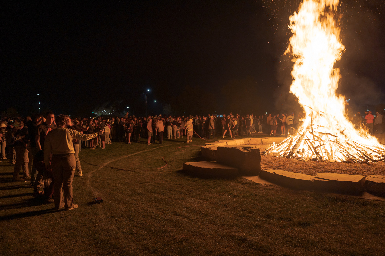 Colorado State University community members roast marshmallows over a bonfire during Friday Night Lights Oct. 14, 2022.