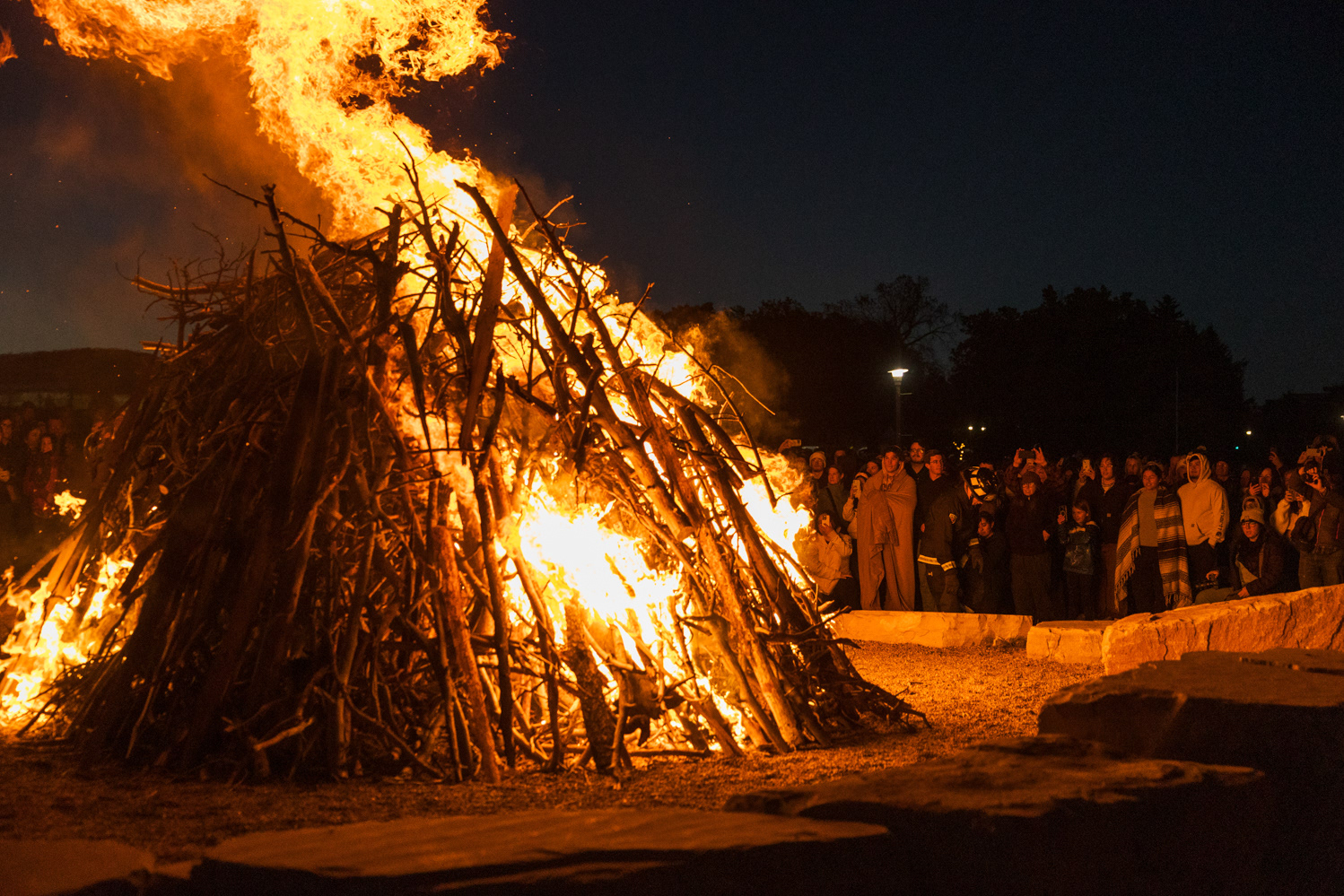 A crowd gathers around the bonfire at Colorado State University's Friday Night Lights Oct. 13. Part of CSU's homecoming celebration, the event features performances from the marching band, color guard and cheerleaders, as well as speeches from sports coaches, a bonfire, fireworks and a DJ performance.