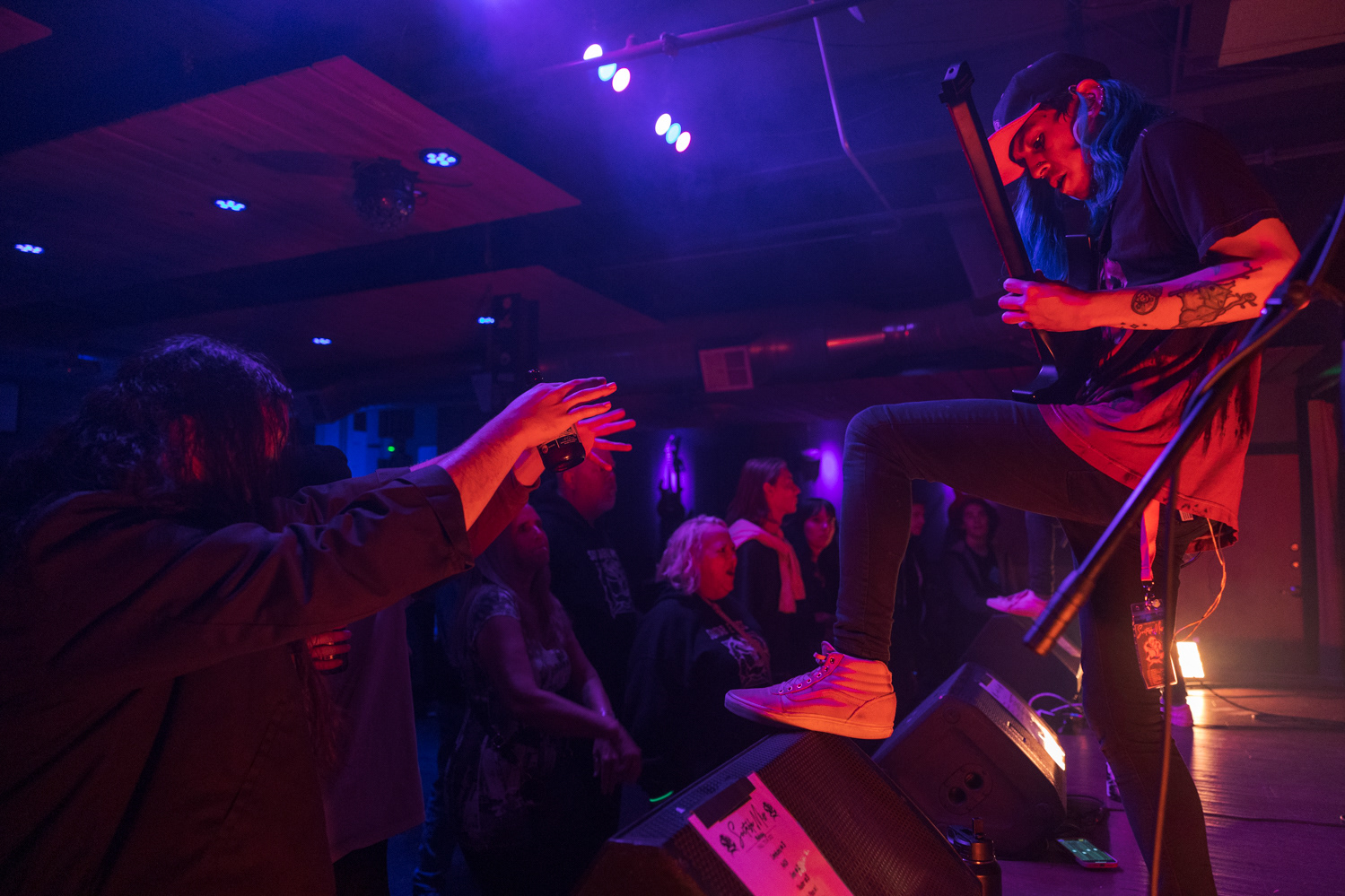 Noah Sauls, guitarist for Denver, Colorado pop-punk band Suitable Miss, stands on a speaker while performing at The Coast during the band's Fall Tour 2022, Oct. 23.