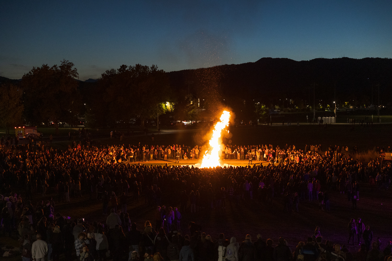 A crowd gathers around the bonfire at Colorado State University's Friday Night Lights Oct. 13. Part of CSU's homecoming celebration, the event features performances from the marching band, color guard and cheerleaders, as well as speeches from sports coaches, a bonfire, fireworks and a DJ performance.
