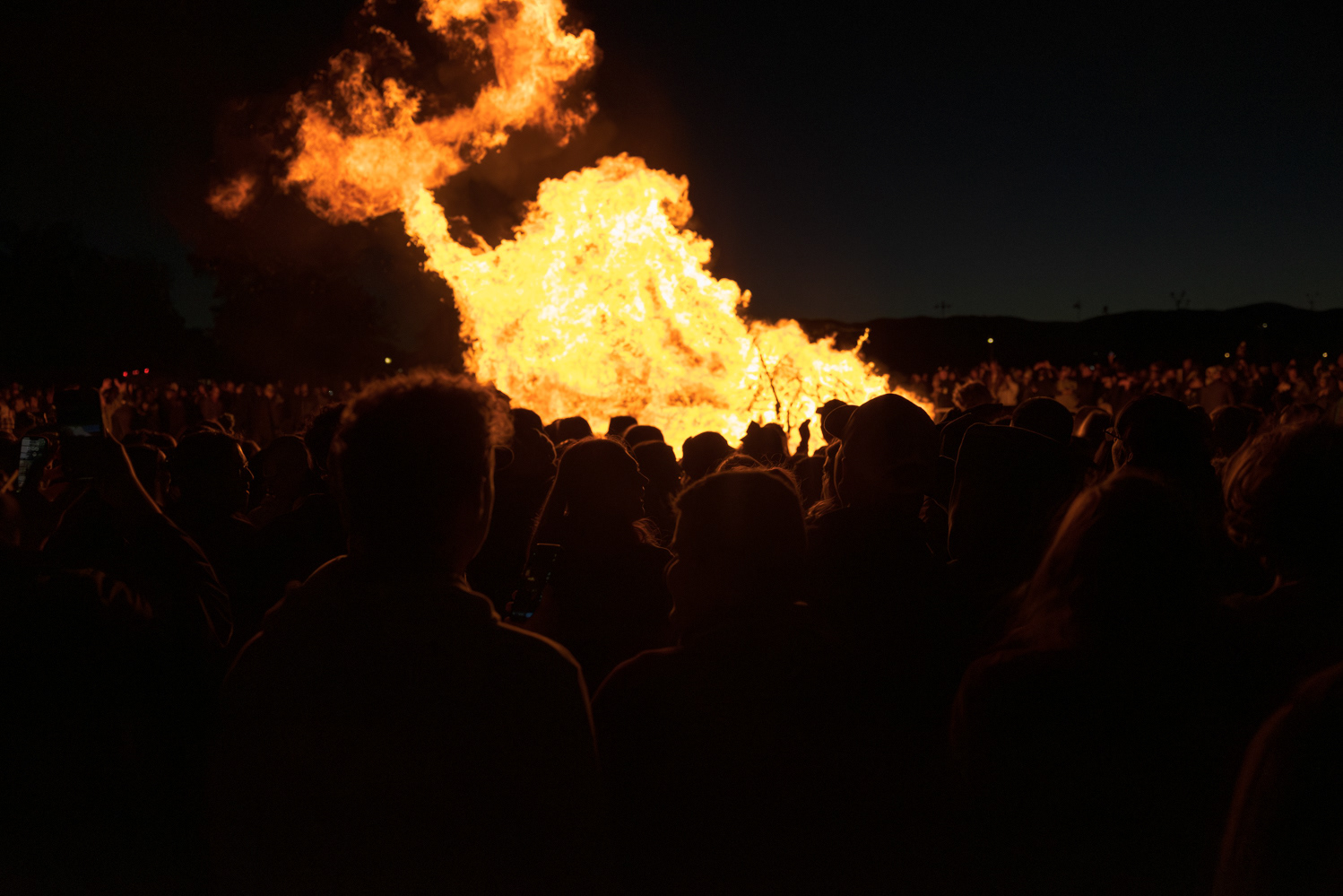 A crowd gathers around the bonfire at Colorado State University's Friday Night Lights Oct. 13. Part of CSU's homecoming celebration, the event features performances from the marching band, color guard and cheerleaders, as well as speeches from sports coaches, a bonfire, fireworks and a DJ performance.